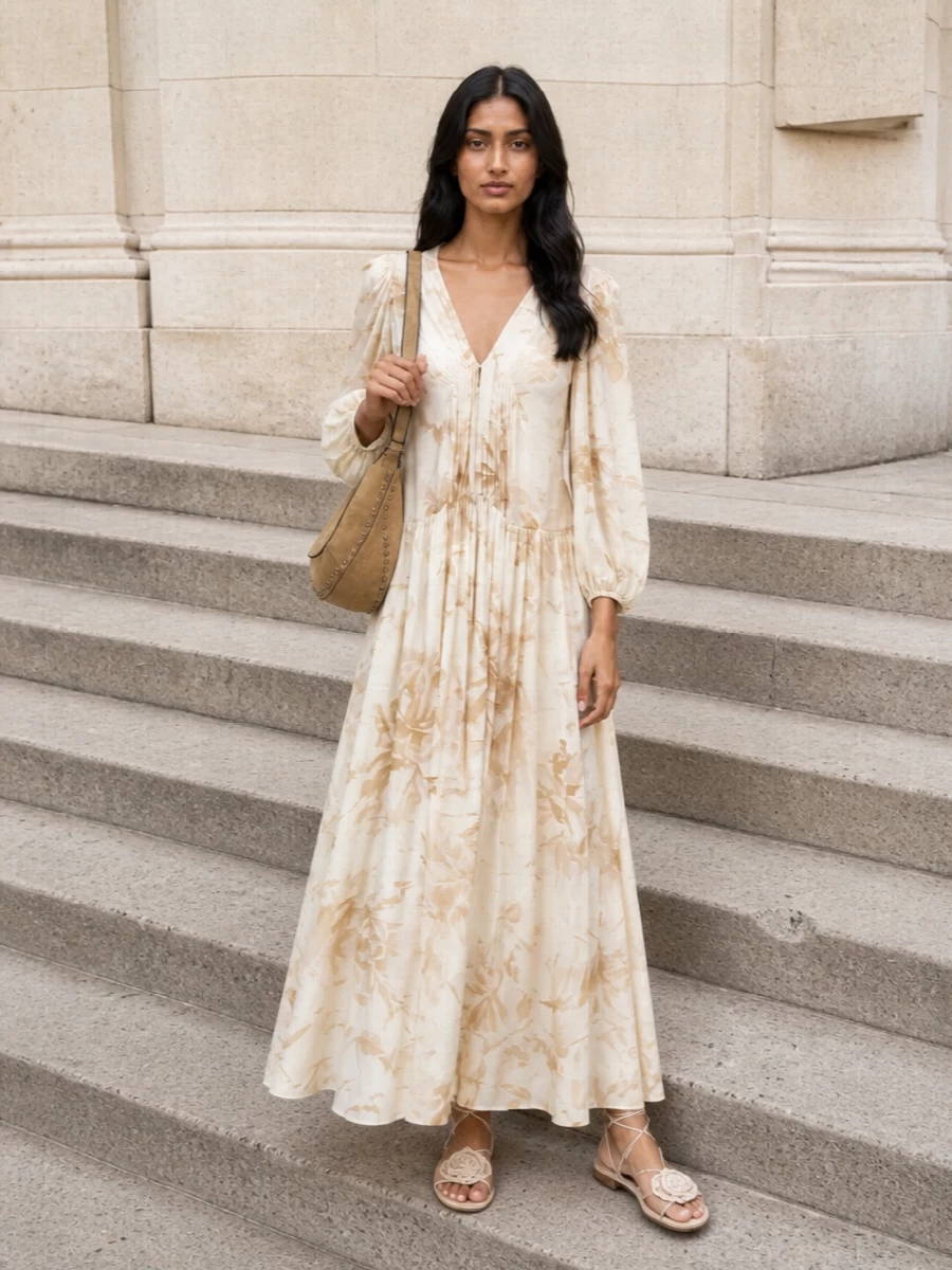 This pairing leans into soft Italian boho, with the Semicouture floral maxi and Isabel Marant suede hobo sitting in the same sun-faded camel and ivory story. The Magda Butrym lace-up sandals keep everything grounded in neutral romance, so the texture and gentle print do the talking rather than hardware or color contrast. Choosing the dress route over separates keeps the silhouette long and fluid, which feels more natural with the curved hobo bag’s easy, slouchy attitude.
