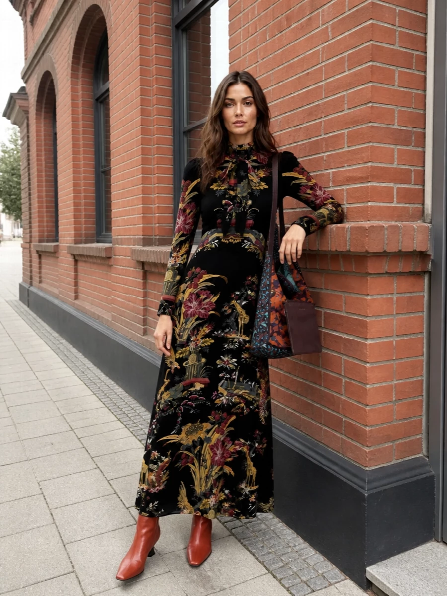 The printed Etro maxi and Dries tote create a rich, storybook palette of garnet, teal, and antique gold, with the bag reading as an art object against the inky ground of the dress. I chose the dress path over separates because the single, sweeping silhouette keeps the prints conversational rather than chaotic and lets the bag’s color play feel intentional. Rust cone-heel boots ground the volume with a modern, romantic edge that still works for real-city days and evenings.