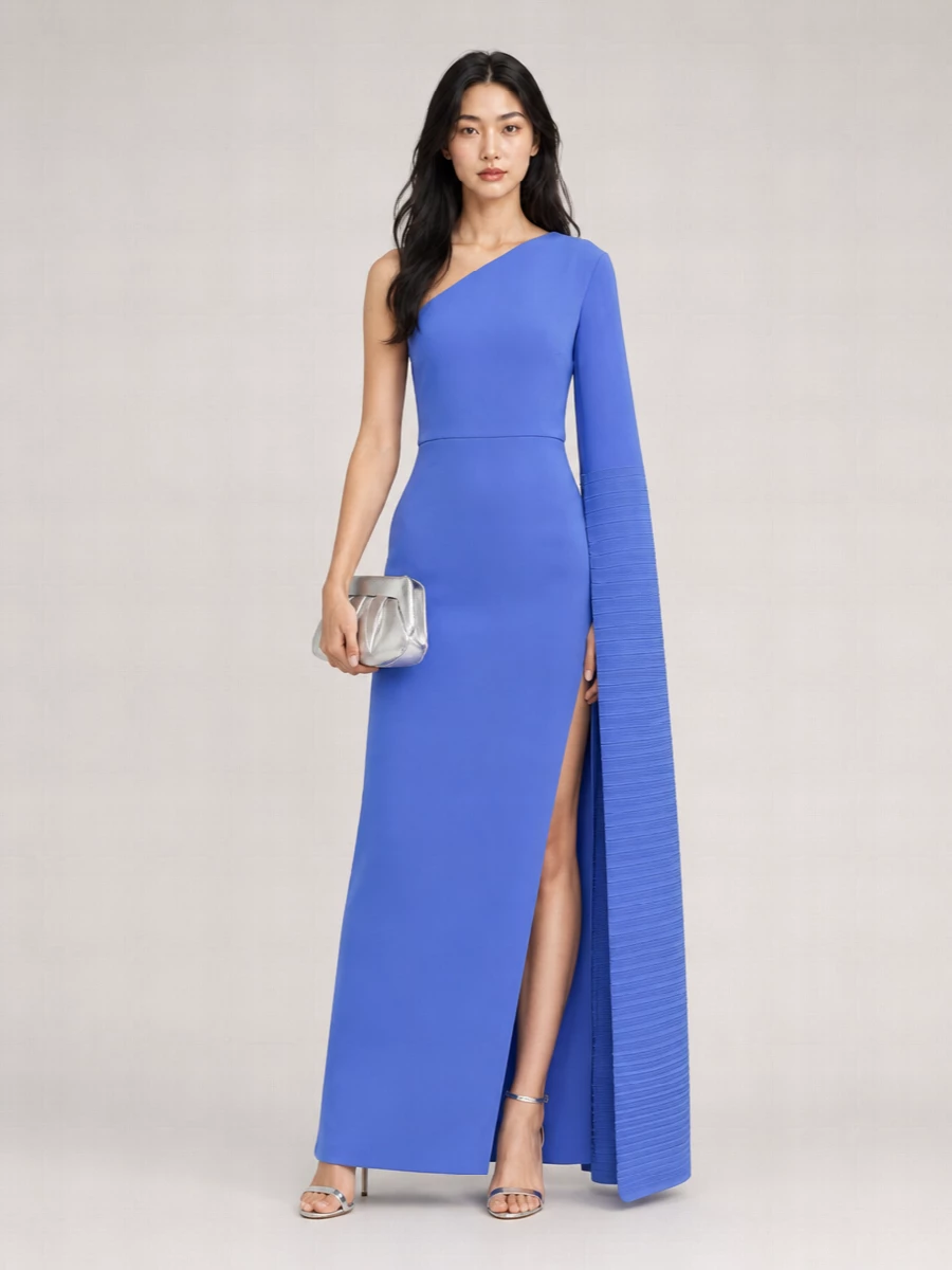 Cobalt and silver keep this evening ensemble graphic and precise, with the dress doing all the color work and the accessories adding clean, mirrored shine. Delicate metallic heels and a sculpted silver clutch stay minimal so the one-shoulder column reads strong and uninterrupted. The gauzy navy wrap is there for a whisper of warmth and shimmer, not to compete with the silhouette.