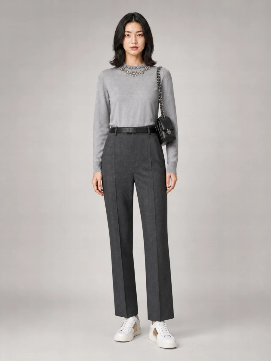 Soft grey crystal framing the face meets impeccably cut charcoal tailoring for a calm, confident city uniform. Clean sneakers and a structured black shoulder bag keep the mood modern and unfussy while still dinner-appropriate. The result is relaxed polish that feels as right for gallery afternoons as low-key evening plans.