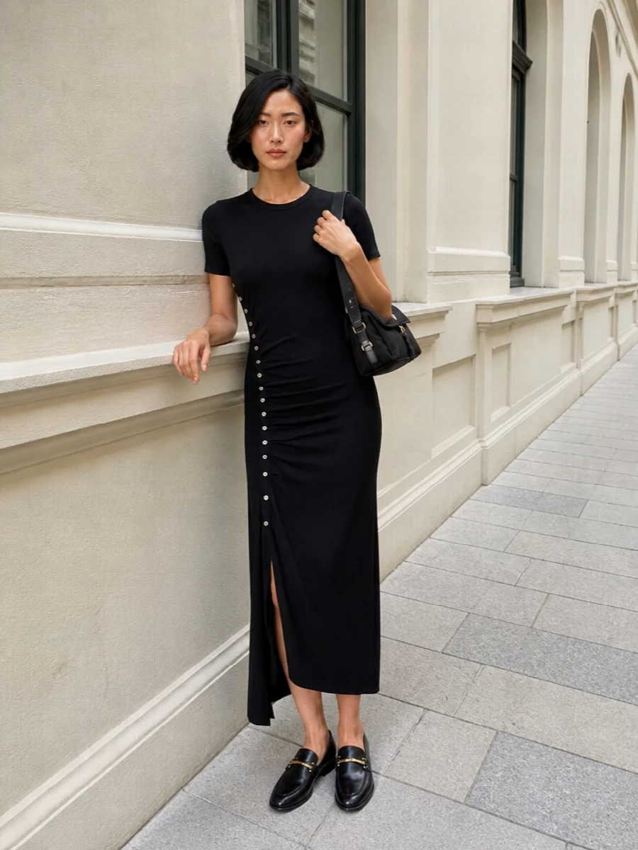 The black asymmetric midi dress and Prada shoulder bag create a clean, columnar silhouette with subtle hardware that quietly ties them together. Sleek black loafers keep the line uninterrupted and the mood polished yet easy, so the whole outfit moves naturally from office to late dinner. I chose the dress path rather than separates to mirror the bag’s unfussy utility and keep the story minimal and uninterrupted in pure black.