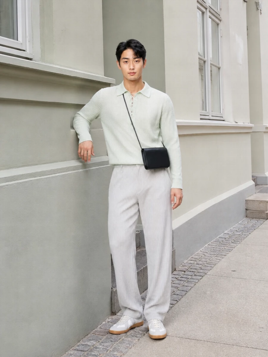Pale mint pleats meet crisp grey-on-white stripes for a column that feels clean, graphic and calm. Soft neutrals at the sneaker and a sharp black shoulder bag keep the mood minimal yet assured, ideal for days that move from studio to dinner without a change.