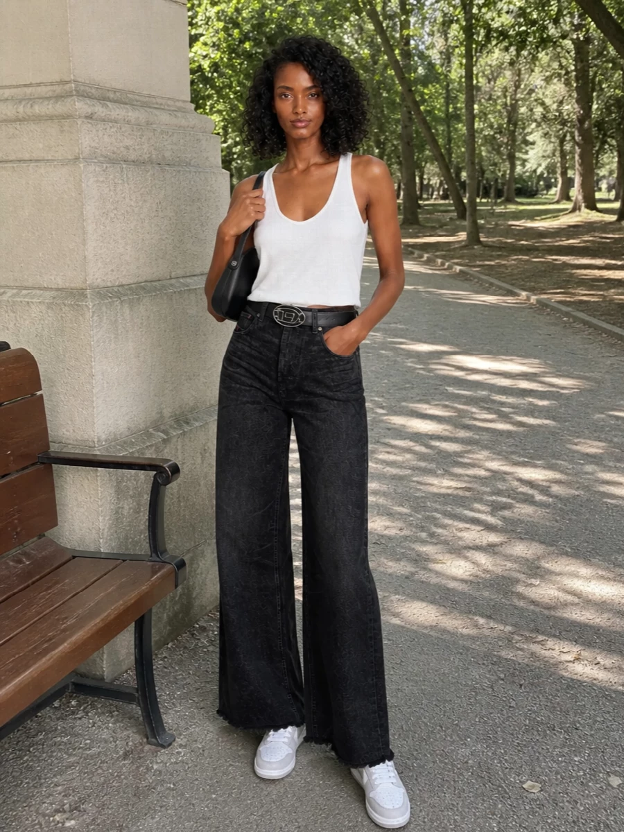 Soft white jersey meets washed-black wide-leg denim for a clean, low-key take on Diesel streetwear. The high-rise, long line and raw hem keep the proportions modern, while crisp white sneakers and a sculpted black mini bag add just enough graphic attitude. A single logo belt pulls it all together without disturbing the minimalist mood.