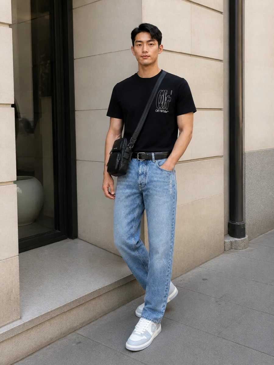 This look centers on the black Off-White tee grounded with light-wash straight-leg denim for a clean, classic SS streetwear silhouette. Optic white and grey Off-White sneakers freshen the palette, while a slim black Prada belt and a compact Balenciaga crossbody tighten everything up into a refined, city-ready uniform that still feels relaxed and easy.