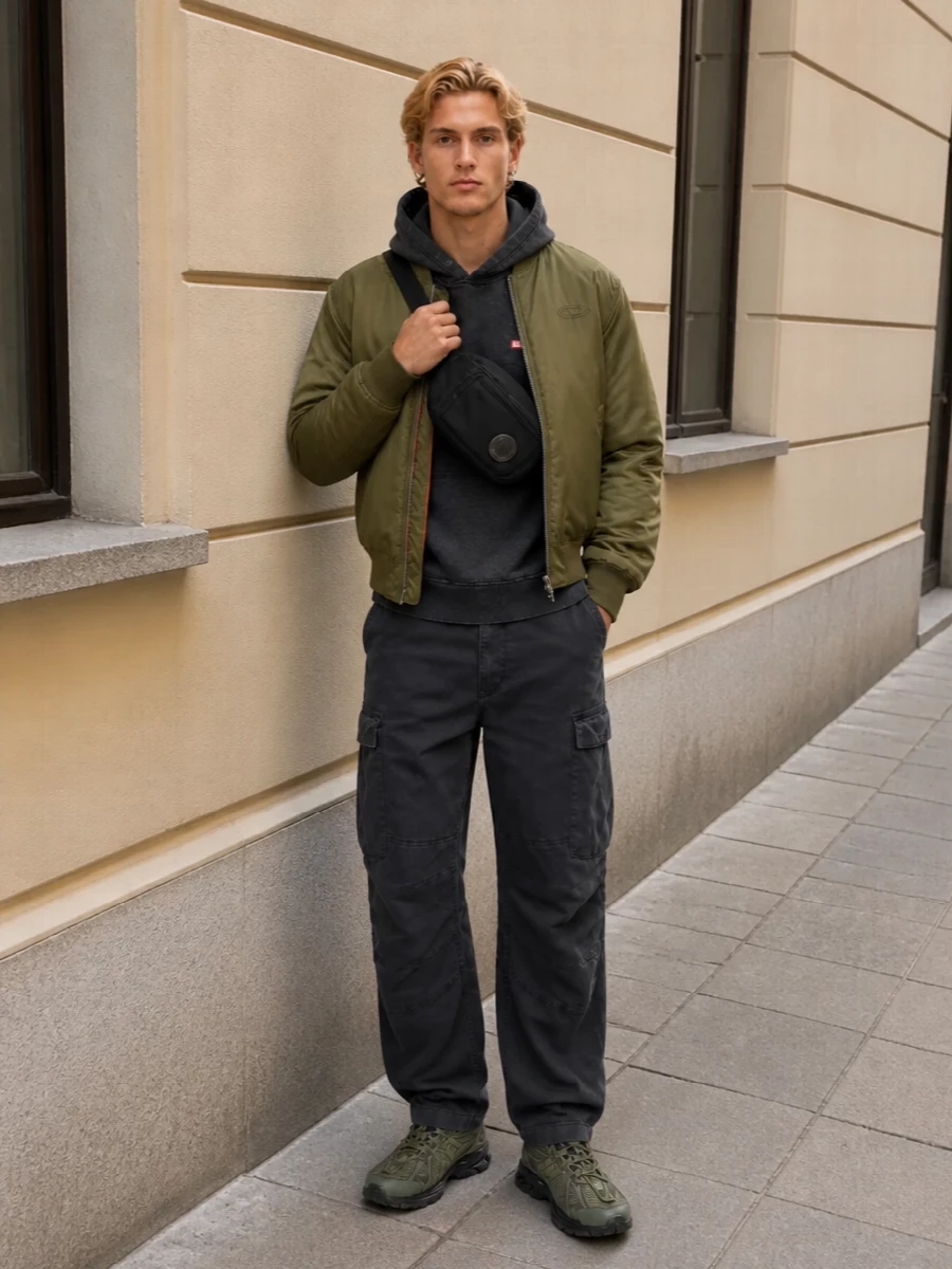 Olive, charcoal and black sit in a tight, utilitarian palette that lets the bomber do the talking while the washed hoodie and cargos bring in that Diesel grit. Technical runners and a compact crossbody keep the energy fast, practical and city-focused, so the whole outfit feels ready for cold-weather movement without losing attitude.