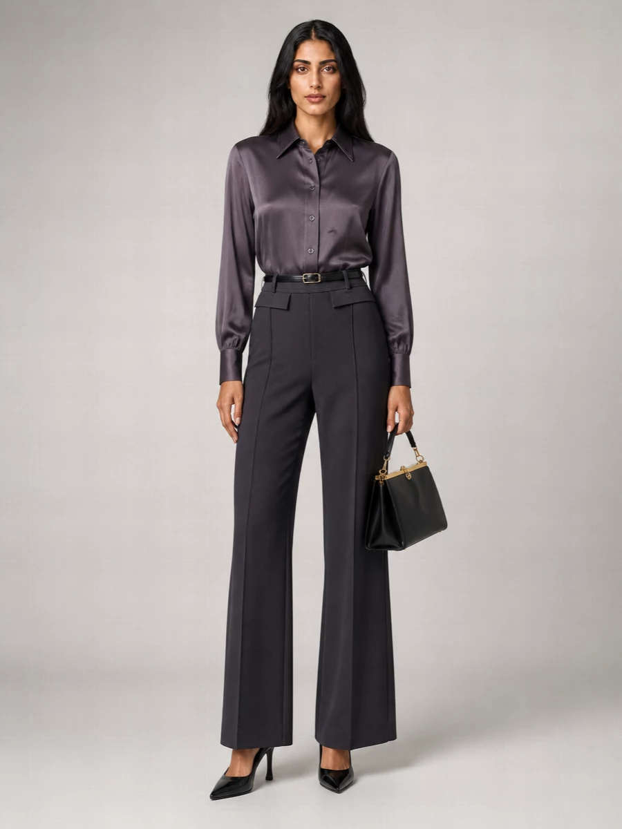 Charcoal satin and tailored wide legs create a long, fluid line that feels polished without being formal. The pointed black slingback and structured black bag sharpen the silhouette, while the slim belt quietly defines the waist. It is an understated, modern way to take this shirt from gallery afternoons into dinner reservations.