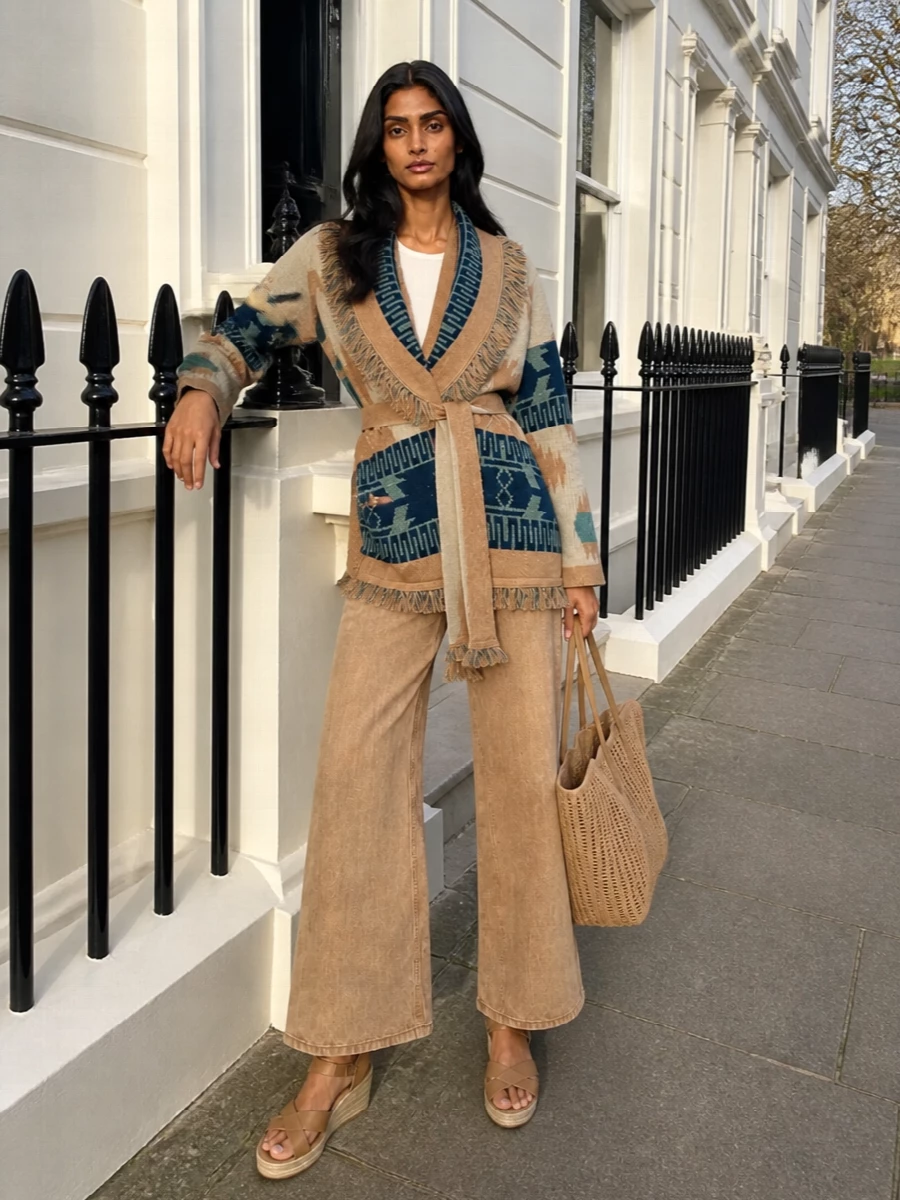 I am styling the Alanui cardigan as the hero layer over foundations rather than pairing it with another knit dress, so I skipped the dress options and built around sculpted bottoms. The camel wide-leg denim with jute wedges and an open-weave tote keep everything sun-ready, relaxed and artisanal while letting the cardigan’s teal and camel jacquard stay the storyline. It reads as an easy, bohemian city-to-riviera ensemble with real quiet-luxury ease.