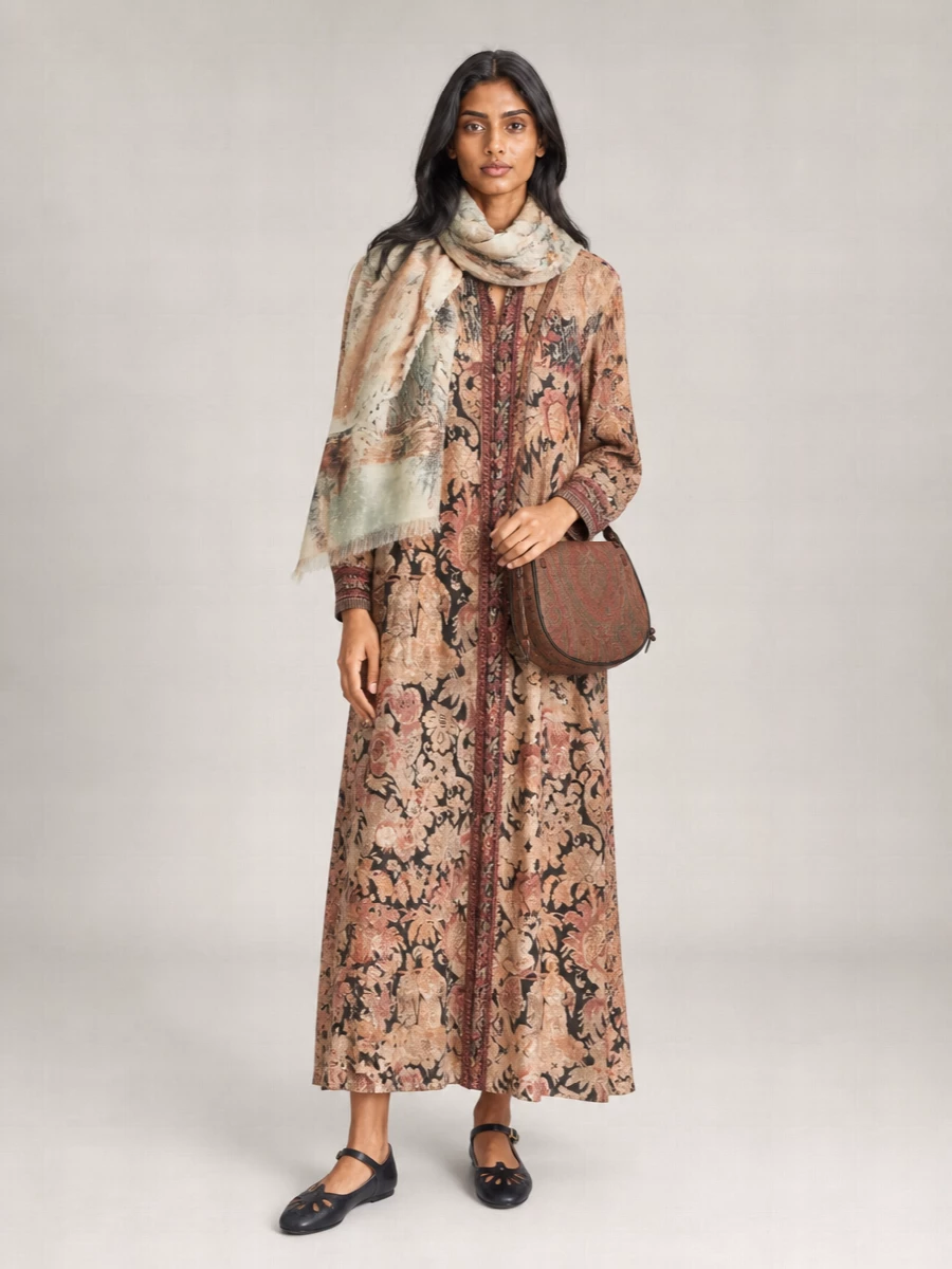 I chose the dress path to let the Pierre Louise Mascia scarf converse with a single, fluid anchor rather than juggling a second bold print in a top and bottom. The tapestry-style shirt dress and gauzy stole read like layered vintage scarves, with the Etro saddle bag and Chloé ballerinas keeping the mood romantic, artful and walkable for cool-city days. It is an intimate, storybook mix of warm neutrals and sage that feels rich without ever tipping into costume.