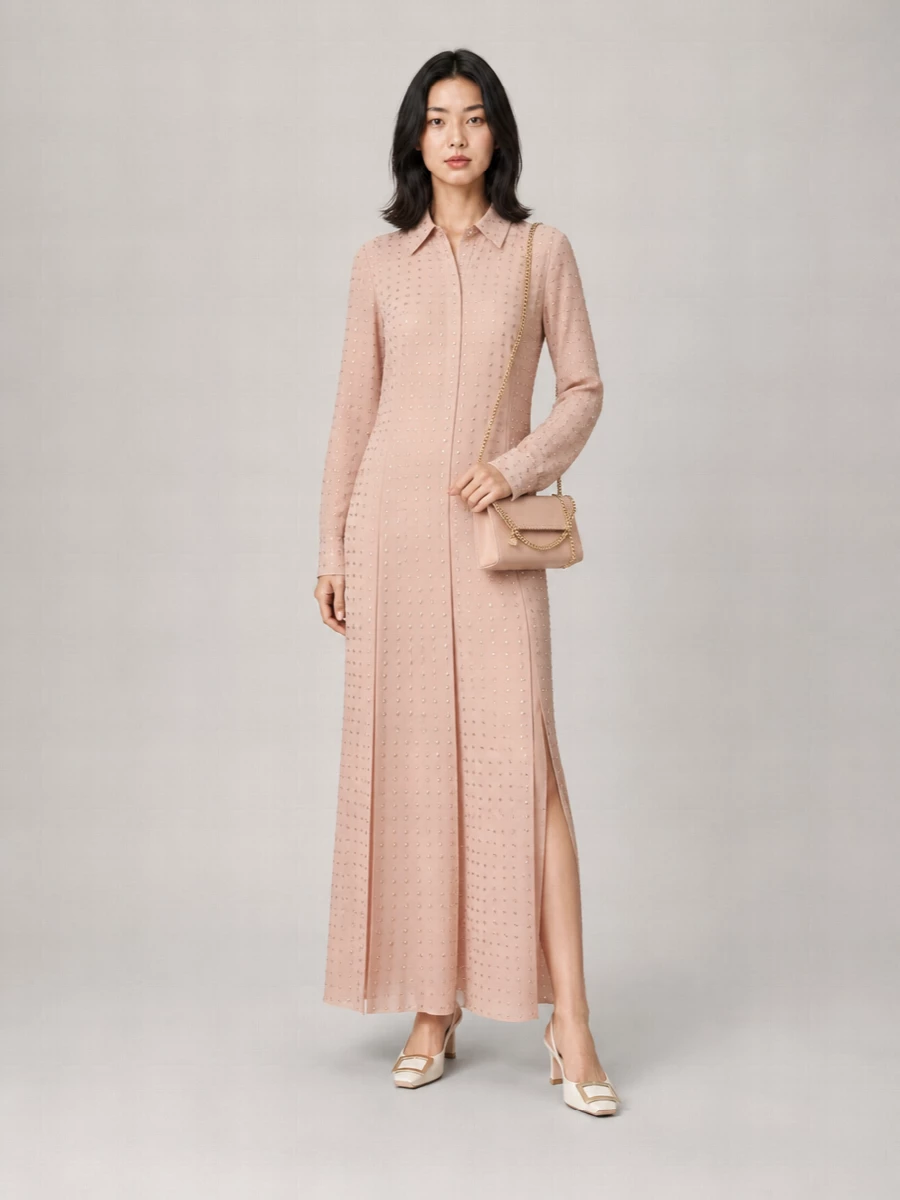 This pairing leans into a blush monochrome story that feels polished yet soft, letting the studded shirt dress and Stella McCartney bag share the spotlight. The long, fluid dress and slim slingback heel create an elongated line that reads ideal for warm-weather dinners and terrace cocktails. Choosing the dress route rather than top and skirt keeps the mood minimal and quietly romantic, which suits the compact, subtly detailed bag best.