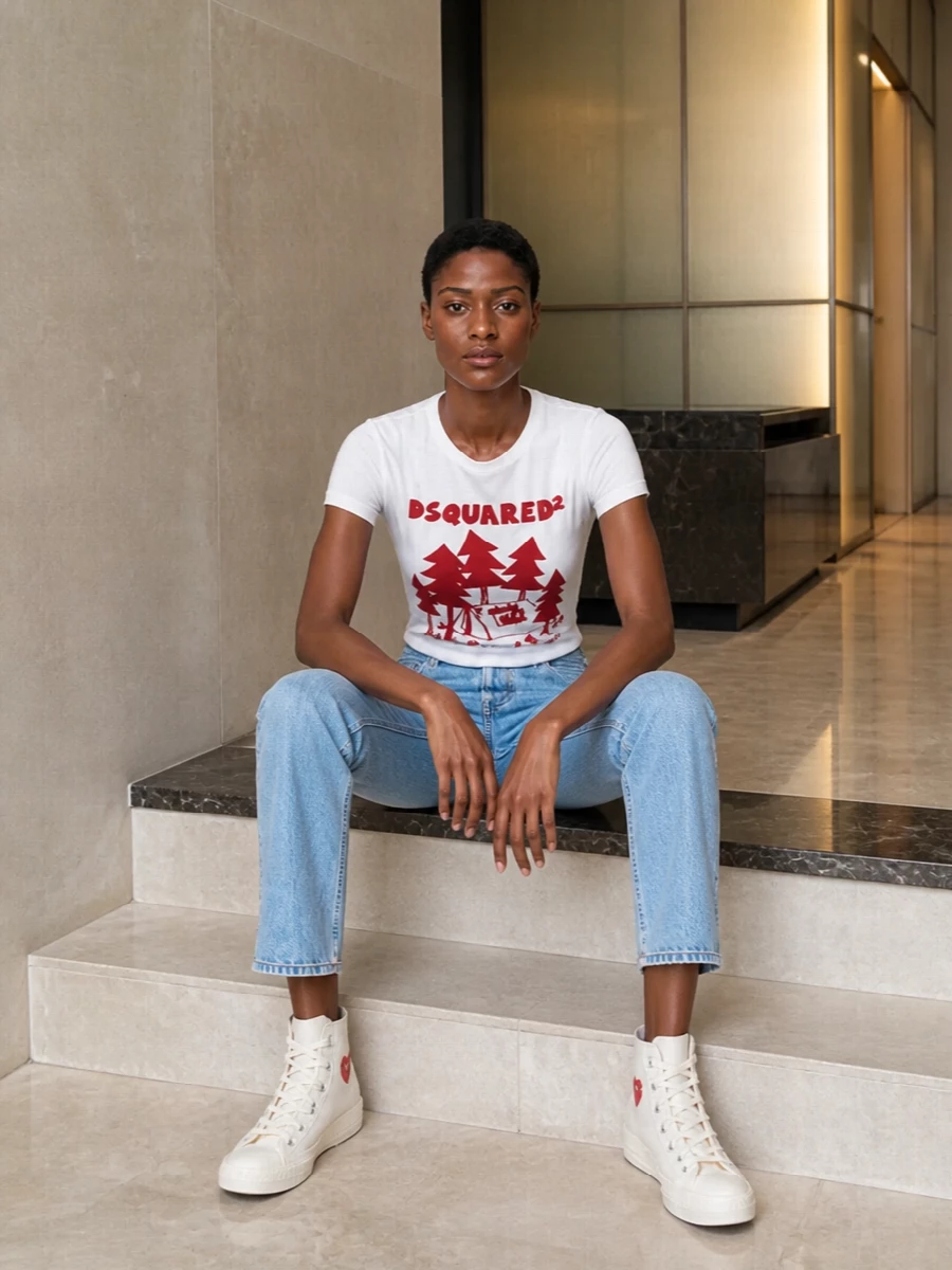 This is an easy, slightly nostalgic streetwear outfit that leans preppy through the clean graphic tee and straight, light-wash denim. The off-white high-tops tie the red hits together and keep everything feeling fresh and relaxed for daytime. Going for jeans and a tee instead of a dress stays closest to how these sneakers really shine: casual, graphic and ready for city days or weekends away.