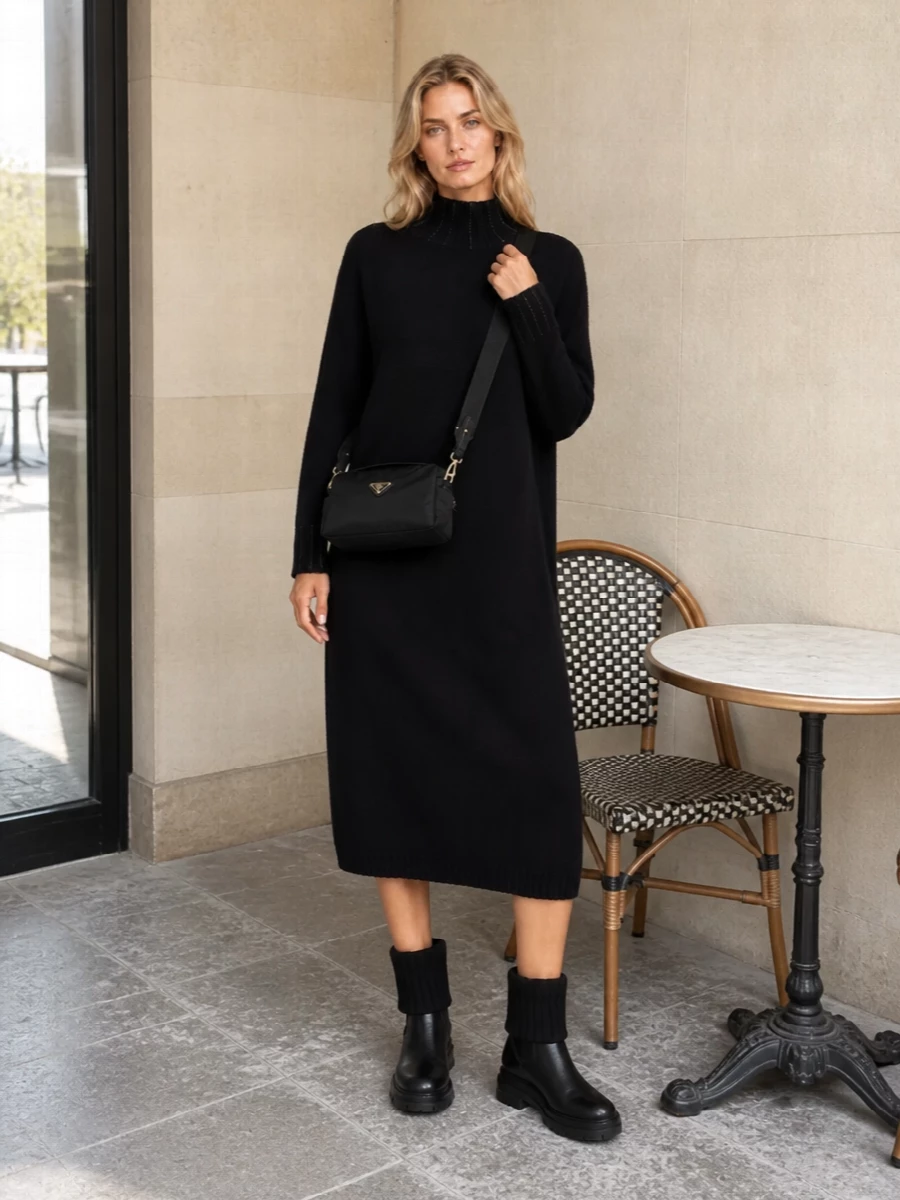 An all‑black, knitted midi dress paired with solid ankle boots is a calm, city-ready answer to the Prada cross-body’s sleek utility. The relaxed straight cut and mid-length keep the silhouette minimal yet considered, while the chunky boot adds just enough attitude for winter streets. Choosing the dress route here keeps the story cleaner and more in line with the bag’s understated sophistication than breaking it into separate top and trouser.