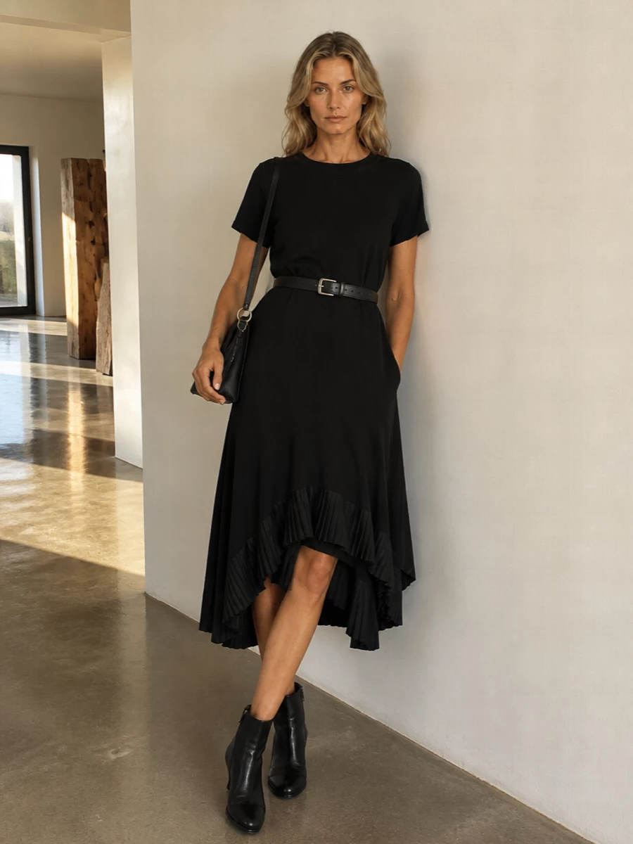A study in black architecture, this pairing lets Sacai’s asymmetric pleats do all the talking. Sculptural ankle boots and a slim Alaïa shoulder bag keep the lines clean and modern, while a precise belt quietly defines the waist without disturbing the dress’s movement.