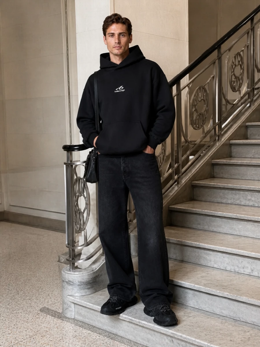 A monochrome Balenciaga uniform built around clean branding and oversized, city-ready proportions. The black hoodie, wide-leg denim and technical runners lean into quiet logo play, while the compact leather pieces keep it edited and intentional. It is a minimalist streetwear take that feels premium without ever reading loud.