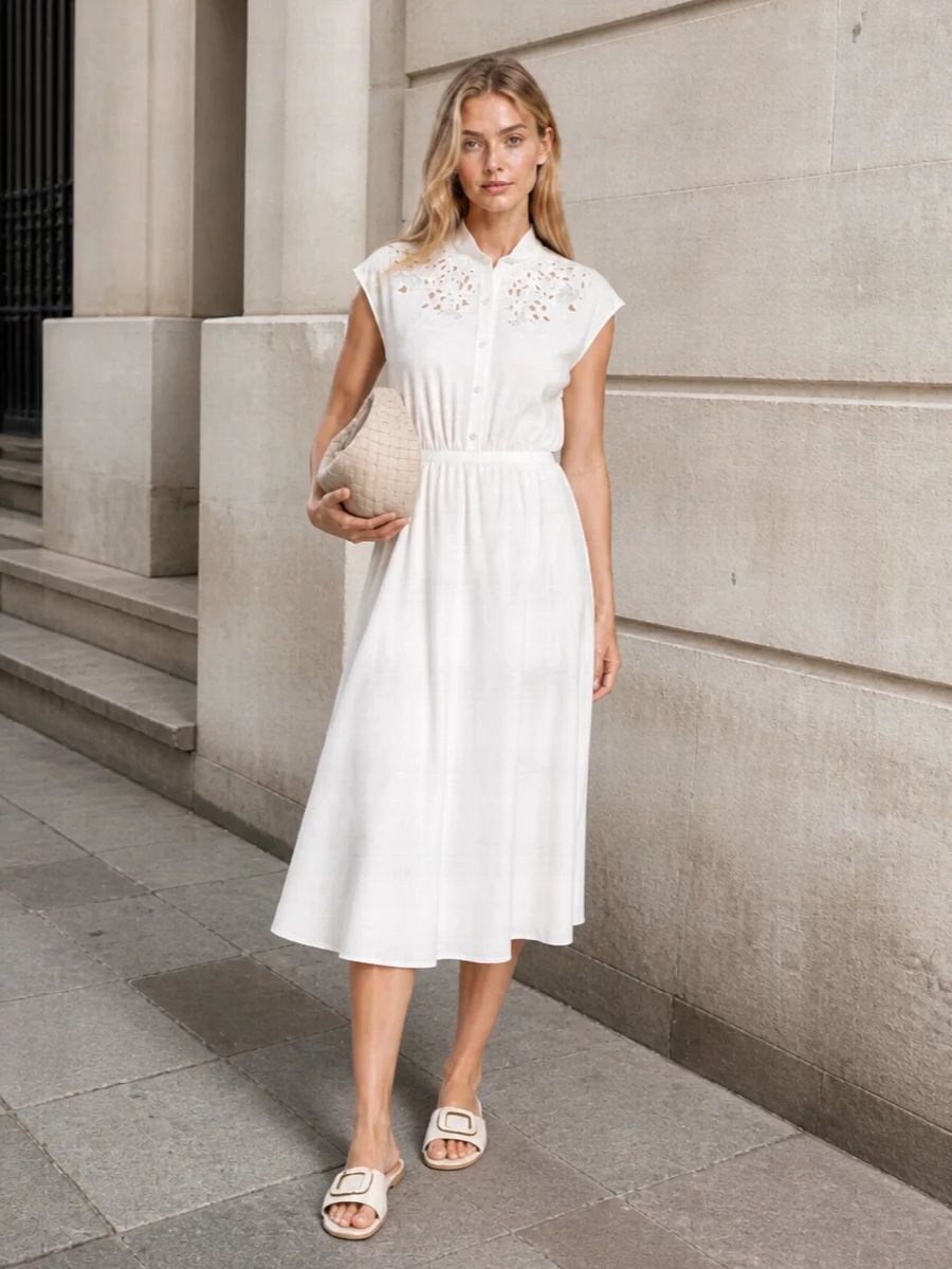 This look leans into a head-to-toe soft-white story: the embroidered midi shirt dress pairs seamlessly with the minimalist Valentino slides for an airy, quietly luxurious SS silhouette. Choosing the dress route over separates keeps the mood breezy and uncomplicated, perfect for resort lunches or luminous city days. The cream intrecciato mini hobo finishes the outfit with subtle texture and discreet polish that doesn’t compete with the clean lines.