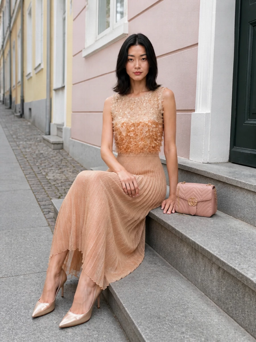 Champagne Louboutin pumps meet a softly shimmering Elisabetta Franchi gown for a long, romantic line that feels made for weddings, gala cocktails or Summer nights with a dress code. The choice of a dress over separates keeps the metallic story quiet and cohesive, letting the pleated skirt move like light around the shoes. A dusty-blush Gucci flap bag finishes the palette in a warm whisper of colour rather than contrast, keeping the whole ensemble firmly in the realm of quiet glamour.