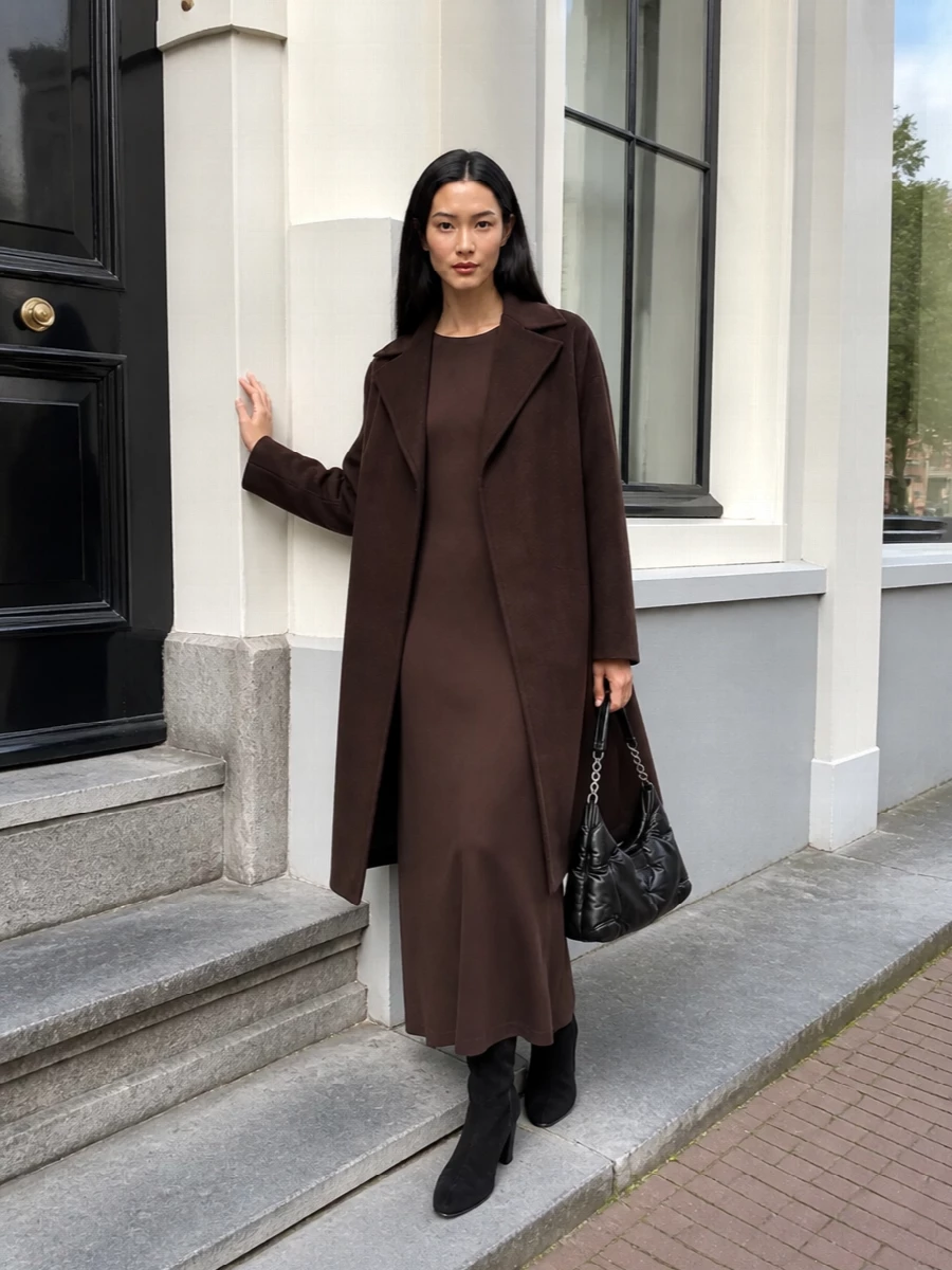 I am building around the dress rather than separates, because the column maxi mirrors the coat’s length and chocolate tone, giving one continuous, calm line that feels truer to quiet luxury. The black knee boot and padded hobo introduce depth through texture, not colour, so the outfit stays minimal yet substantial for city evenings or formal days. Head-to-toe, it reads composed and grown up, with the coat acting almost like a soft, tailored shell around a fluid brown column.