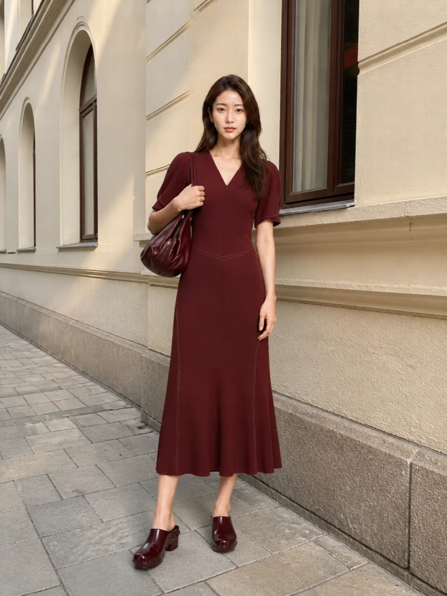 Deep burgundy on burgundy turns the Bottega mules into part of a rich, tonal story rather than a standalone statement. The Victoria Beckham midi keeps the silhouette long and sculpted, so the chunky studded heel feels deliberate and modern instead of heavy. With the soft Versace shoulder bag echoing the colour and adding a little slouch, you get a quietly glamorous evening outfit with a subtle y2k attitude in the details rather than the cut.