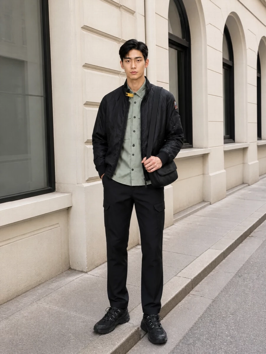 This is a tight, city-ready technical uniform built around the Parajumpers bomber, with a sage utility shirt and sleek black cargo trousers keeping the palette controlled and functional. All-black Salomon runners and a padded C.P. Company crossbody finish it with trail-informed practicality, so the yellow tab and subtle hardware become the only real hits of contrast. It feels engineered for movement, commutes and travel days where you want gear that looks as sharp as it performs.