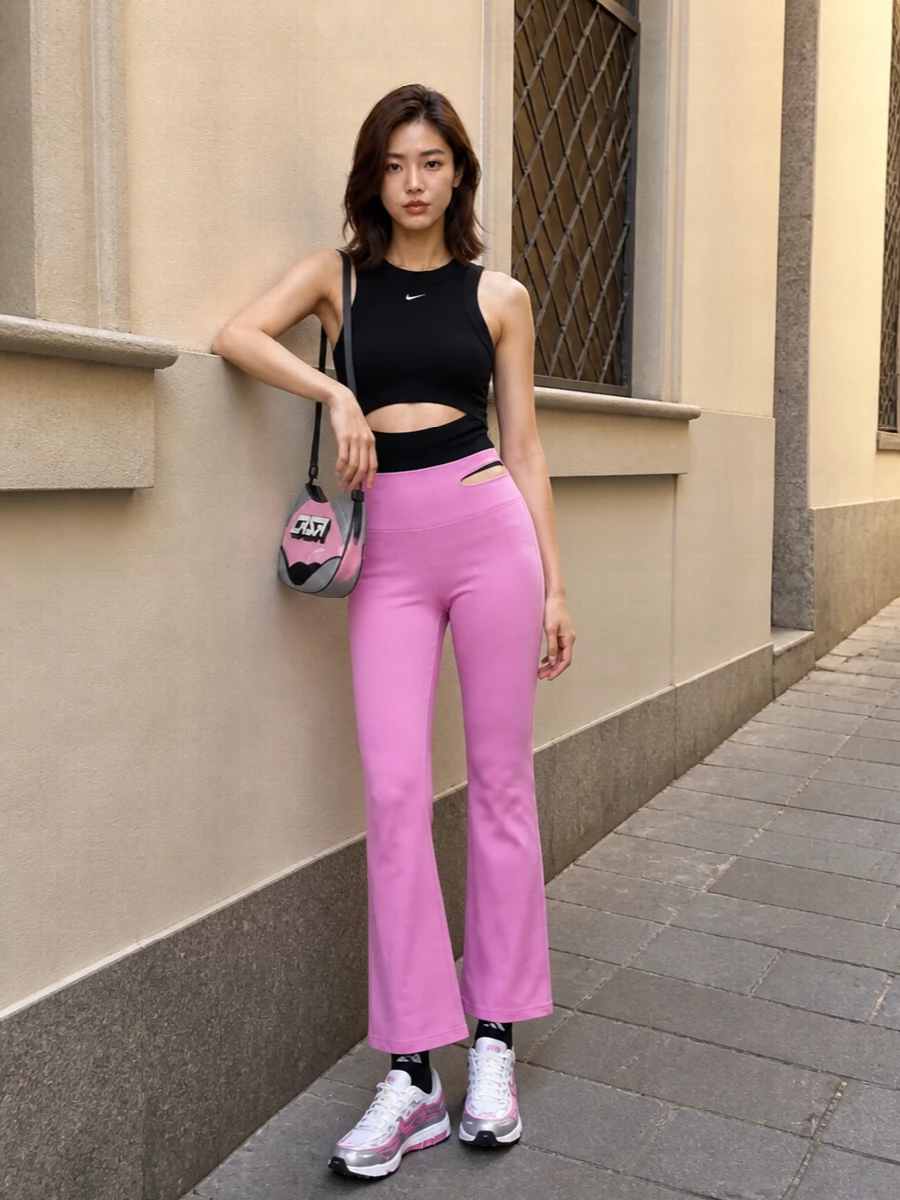 Bubblegum flares meet a sharp black cut-out tank for a studio-to-night vibe that is pure Y2K sport. White and pink runners keep it fast and playful, while the compact Casablanca bag and logo socks add small, graphic hits that make the pink feel intentional rather than sweet.