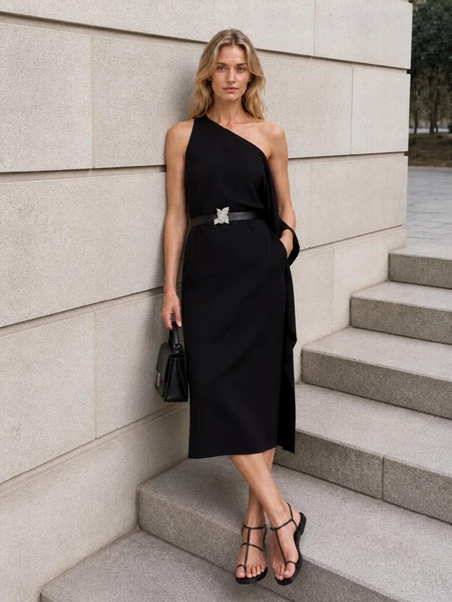 Anchoring the Our Legacy belt against Loulou Studio’s one-shoulder black midi lets the sculptural buckle read as a considered focal point rather than competing with tailoring. Flat, barely-there Givenchy sandals and a compact black top-handle bag keep everything low to the ground and quiet, so the interest stays on shape, line and that talismanic hardware. It feels like modern city evening dressing for someone who prefers ease and restraint over height and gloss.