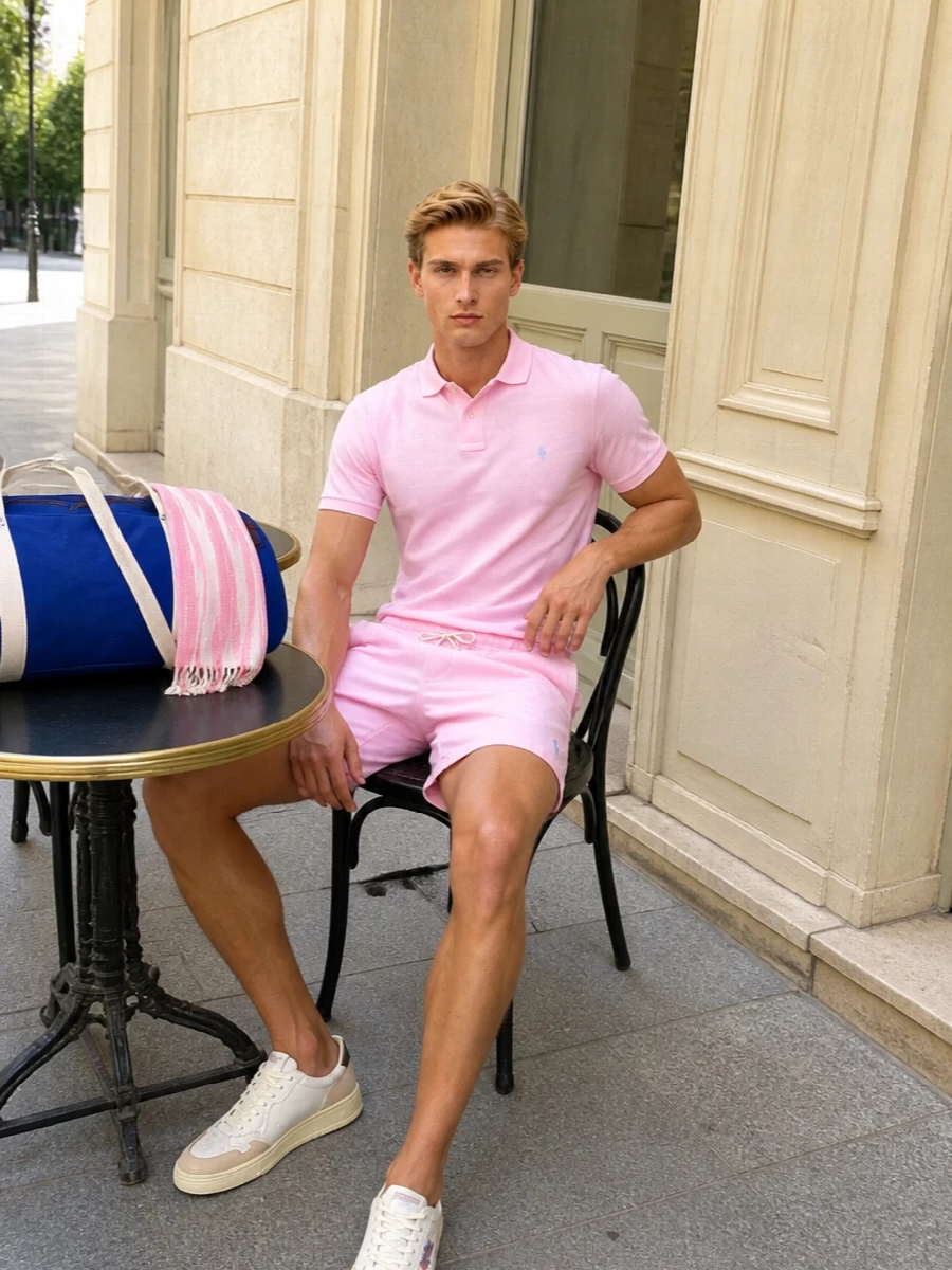 Soft pink on pink keeps this Polo Ralph Lauren set clean and quietly confident, with the drawstring short and piqué polo reading as easy summer prep rather than statement. Off-white retro sneakers and the royal-blue duffle pull in classic court and campus references, giving you a sharp but relaxed way to move from beach club mornings to casual city afternoons. The striped scarf adds just enough texture and movement to stop the pastels feeling flat while still keeping everything light and breathable.