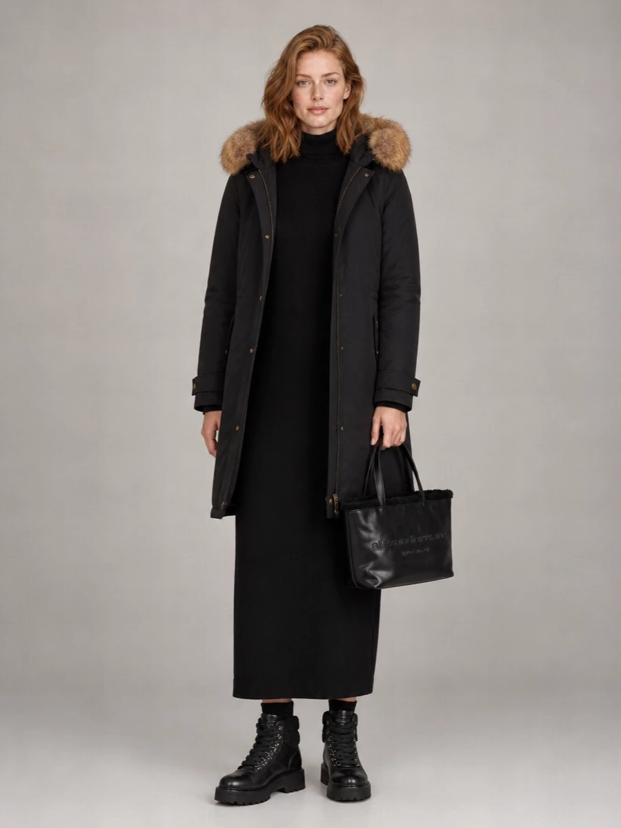 I’m taking the knit dress path rather than top and bottom, because the parka already brings volume and function and a single long column underneath keeps the whole story clean and intentional. The black Uma Wang dress, Woolrich hiker boots and compact Alexander Wang tote create a dark, streamlined winter uniform that feels practical on the street but still quietly luxurious. It is the sort of outfit you live in when the temperature drops, with texture doing the talking instead of color.