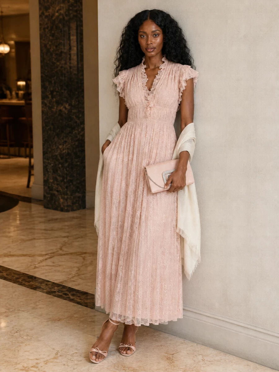 A blush Alberta Ferretti lace maxi meets equally soft accessories for a garden‑wedding ready ensemble that feels romantic but composed. Barely‑there blush sandals keep the pleated skirt floating, while a crystalline blush clutch and whisper‑light ivory wrap add just enough evening polish for twilight terraces and candlelit receptions.