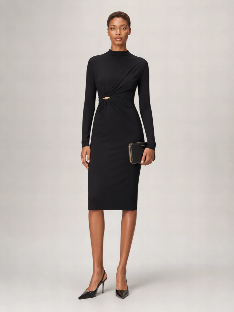 Opt for the Bottega Veneta long-sleeve black dress cinched with sculptural gold hardware to echo the Saint Laurent slingback’s precise, pointed energy. The covered arm, close-cut column and high neckline keep everything quietly powerful, while the gold clasp draws the eye to the waist instead of the hem. A structured black-and-gold clutch sharpens the line and lets the shoes read as the final, razor-clean punctuation.