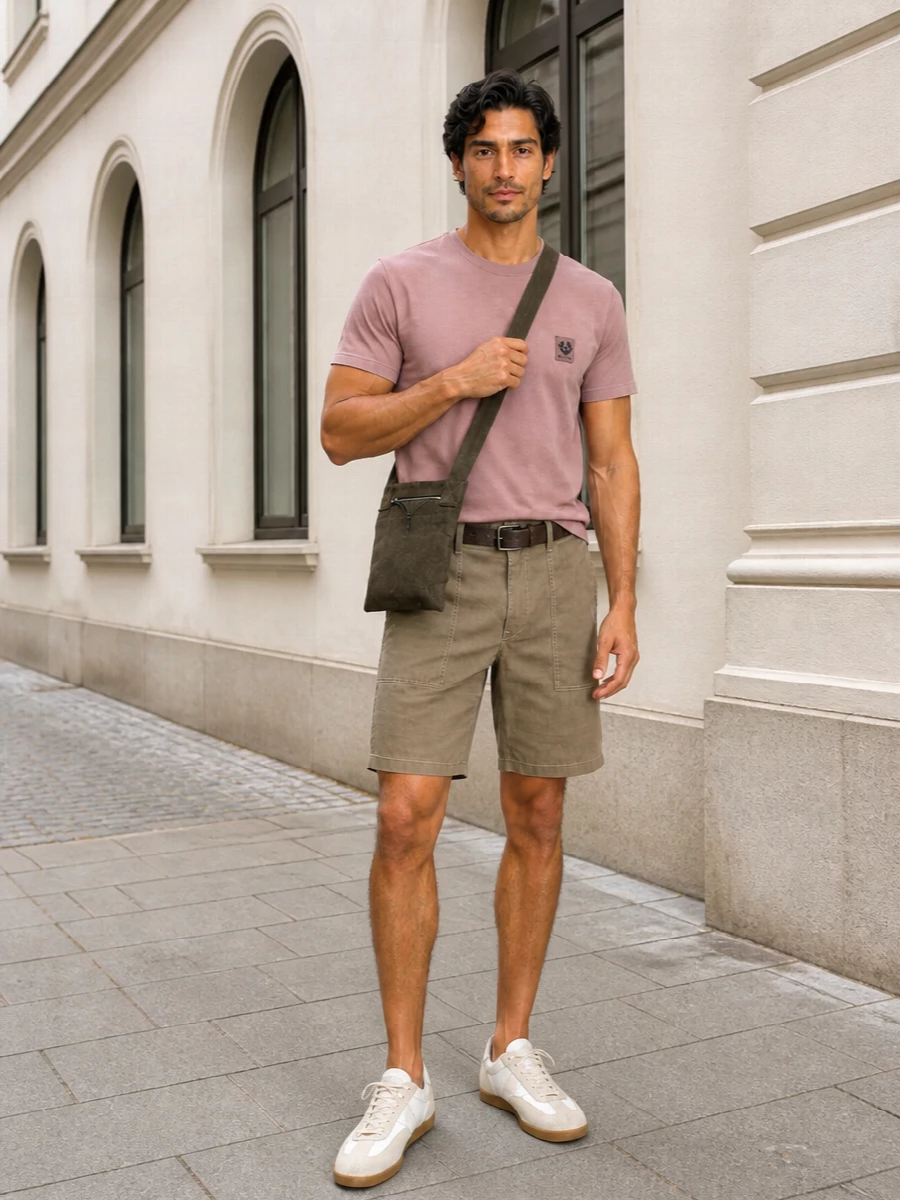 Dusty rose, soft khaki and warm neutrals come together for a calm, street-informed summer outfit that feels considered without trying too hard. The regular tee and relaxed cargo short keep the silhouette easy, while textural sneakers, a slim belt and a close-sitting crossbody add just enough structure for city days and casual evenings. It is an unfussy way to do colour that still reads quietly refined and modern.