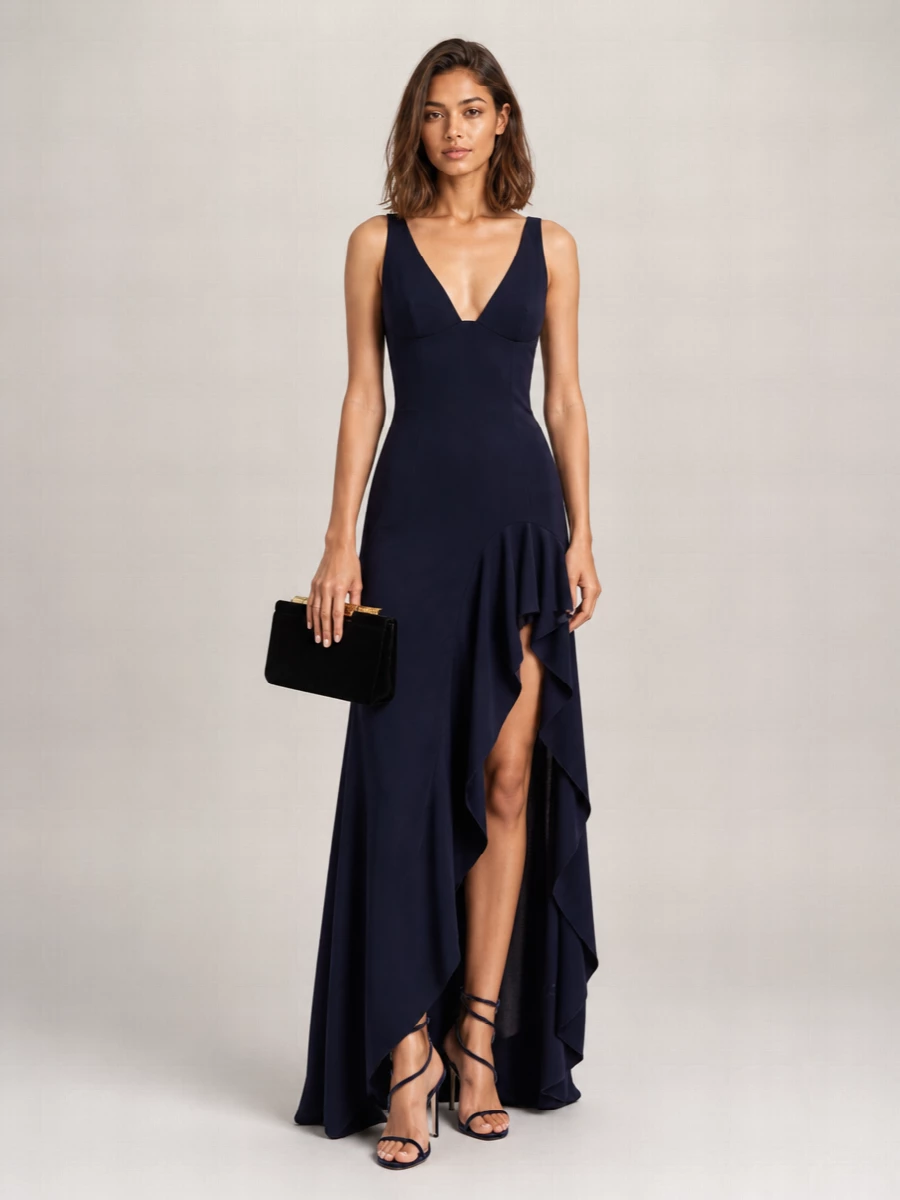 This is a deep-night column of navy and black, where the Stella McCartney gown and Rene Caovilla spiral sandals work together to lengthen and sculpt the silhouette. The fluid ruffled hem and inky velvet straps feel romantic rather than showy, while the Dolce&Gabbana velvet clutch keeps the texture story rich and the hardware discreet. I chose the dress route here to let the shoes and gown read as one continuous, elongated line instead of breaking the body with separates.