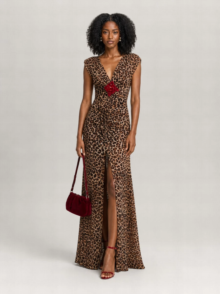 A sultry leopard gown stays in focus, framed by glossy red sandals that pick up the floral detail and a garnet velvet clutch that deepens the palette. Pearl-drop studs add just enough glow, while a leopard silk square is there if you want one extra hint of Sicilian glamour. The effect is unapologetically romantic, high-octane evening drama that still feels considered and cohesive from head to toe.