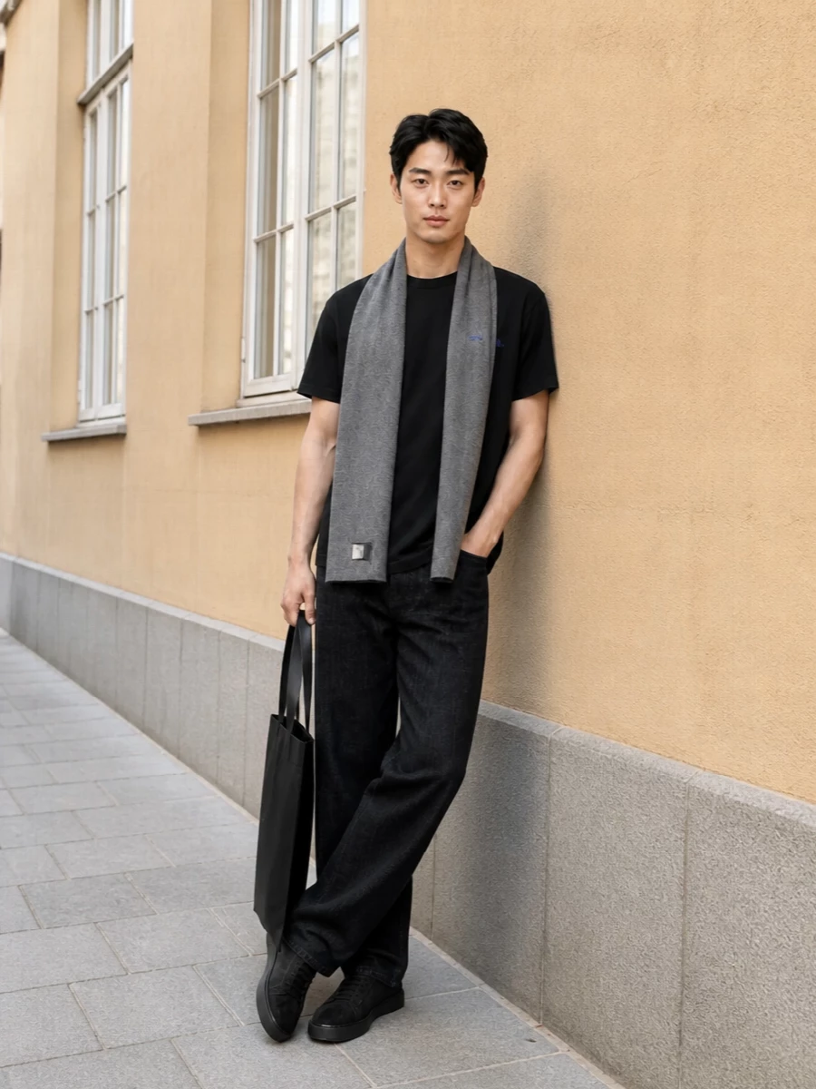 Black on black, anchored by the Jil tee and washed Jacquemus denim, keeps the mood calm and precise. Dark suede sneakers and the flat Jil tote lean it toward city days where comfort has a sharp edge. A soft grey scarf adds just enough texture to stop the monochrome from feeling flat while staying firmly in the quiet‑luxury lane.