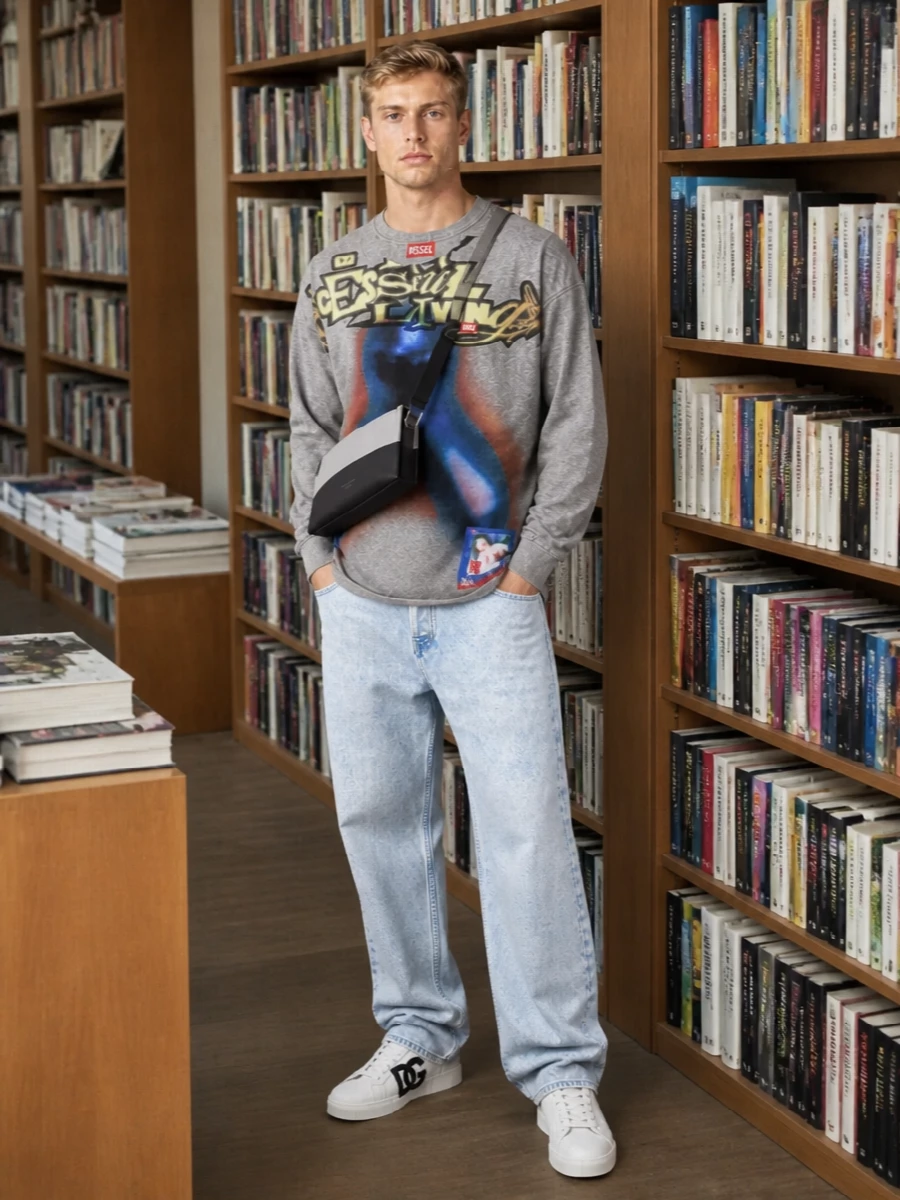 The heather-grey Diesel graphic tee sits over bleached loose denim for a true early-2000s street silhouette that feels easy and bright. Clean white-and-black sneakers and a streamlined two-tone belt bag sharpen the palette without stealing focus from the airbrushed artwork. The result is relaxed but intentional, made for skate-park days that run straight into night.