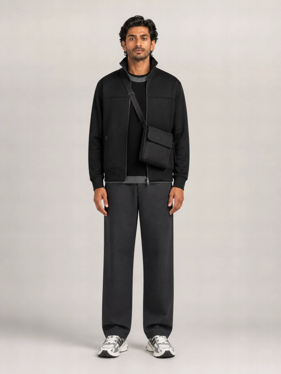 A monochrome Margiela-led track set that leans into clean lines and subtle texture shifts rather than logos. The charcoal knit and trouser calm the technical jacket, while neutral runners and a slim crossbody keep everything sharp and city ready.