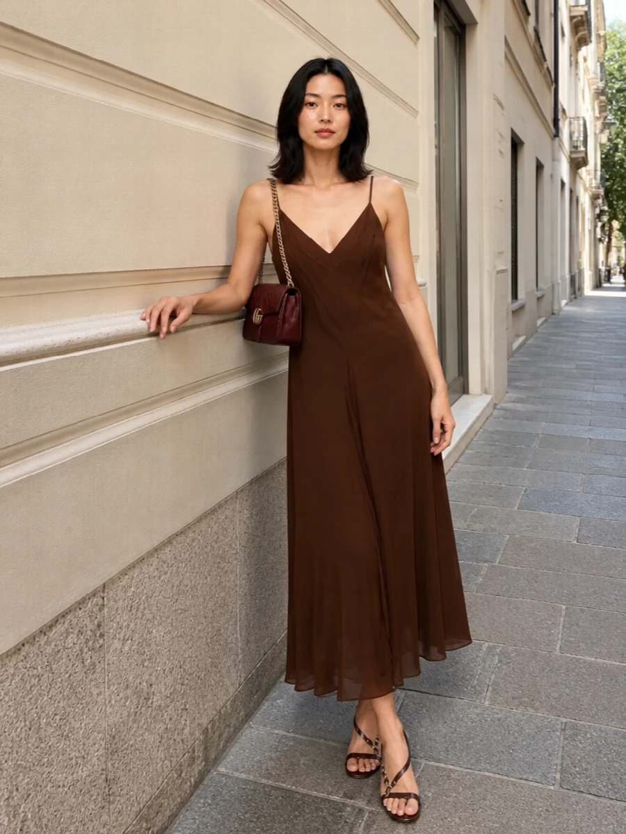A fluid chocolate slip dress and the quilted burgundy shoulder bag create a quietly romantic evening story in deep, gourmand tones. The slim, strappy heel keeps the line long and modern while staying understated so the textures and gold accents can do the talking. Choosing the dress path here keeps the outfit focused and grown-up, better echoing the bag’s sensual, cocktail-ready mood than a playful mini-skirt combination would.