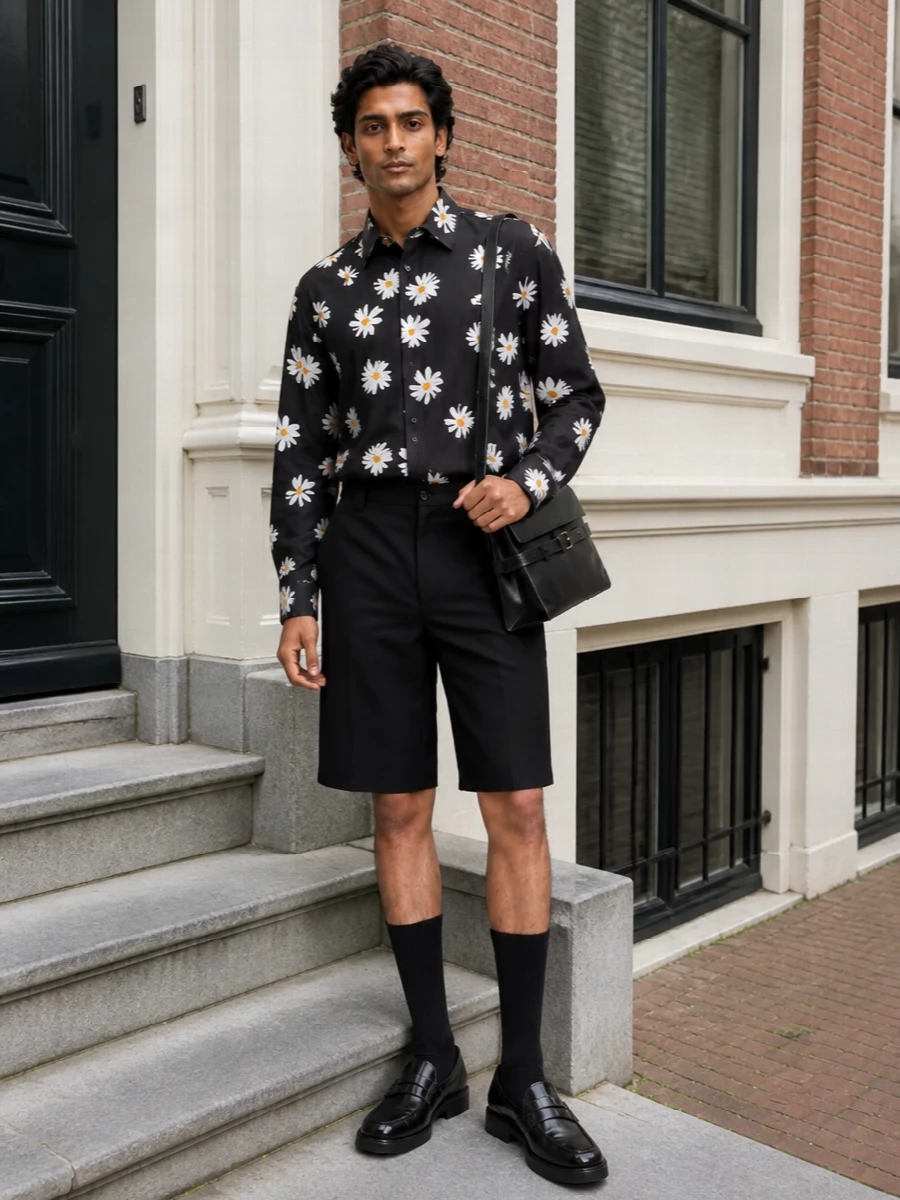 Moschino’s daisy shirt stays centre stage, grounded by clean black tailored cargo shorts that keep the print sharp rather than shouty. Polished black loafers and a structured shoulder bag pull it toward smart city dressing, giving you a romantic, graphic summer uniform that still feels grown up.