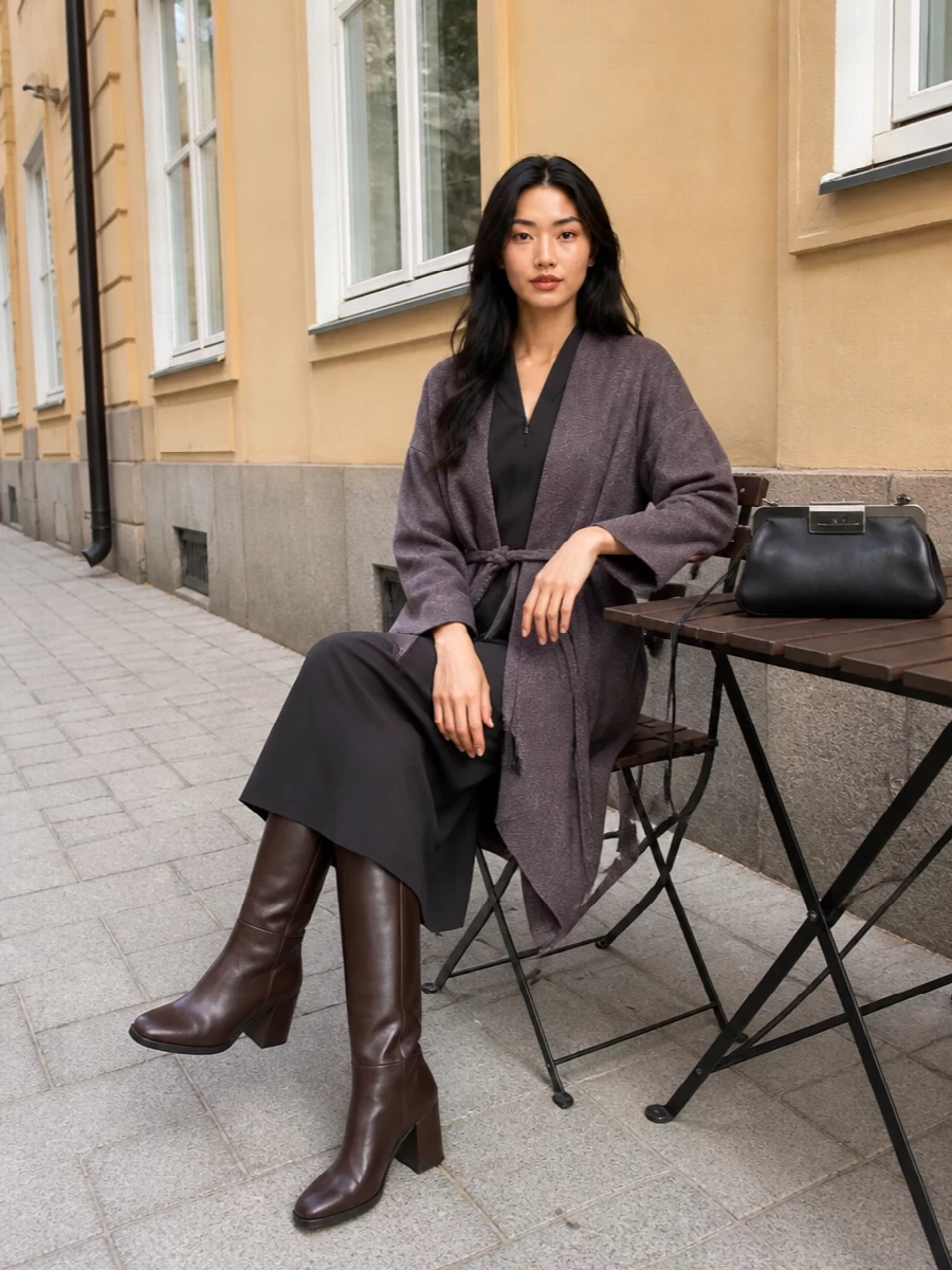 I am styling this as a dress-based ensemble so the Armani coat can read as a cocoon around a single, clean charcoal column. The fitted midi dress, sculpted knee-high boot and compact frame bag create a quiet, gallery-or-restaurant evening mood that feels deliberate but not severe. The palette stays in mauve taupe, charcoal and deep brown, so the texture and proportion do the talking rather than any high-contrast detail.