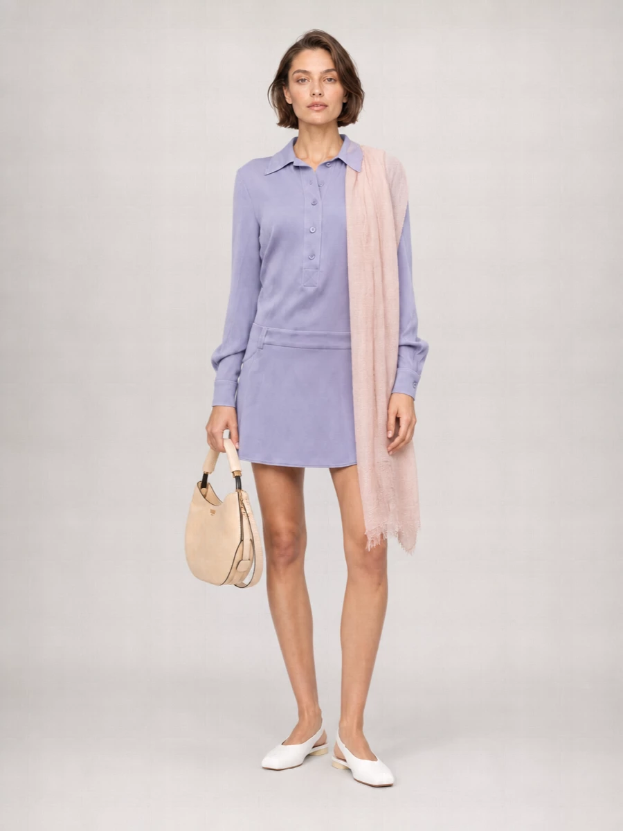Periwinkle tailoring meets soft suiting in a fresh, polished outfit built around clean lines and light neutrals. The high-waisted cream trousers lengthen the leg and temper the blouse’s mini-inspired energy, while pale accessories in white, nude and blush keep the mood gentle rather than stark. It is an easy, modern option for warm days when you want structure that still feels relaxed and feminine.