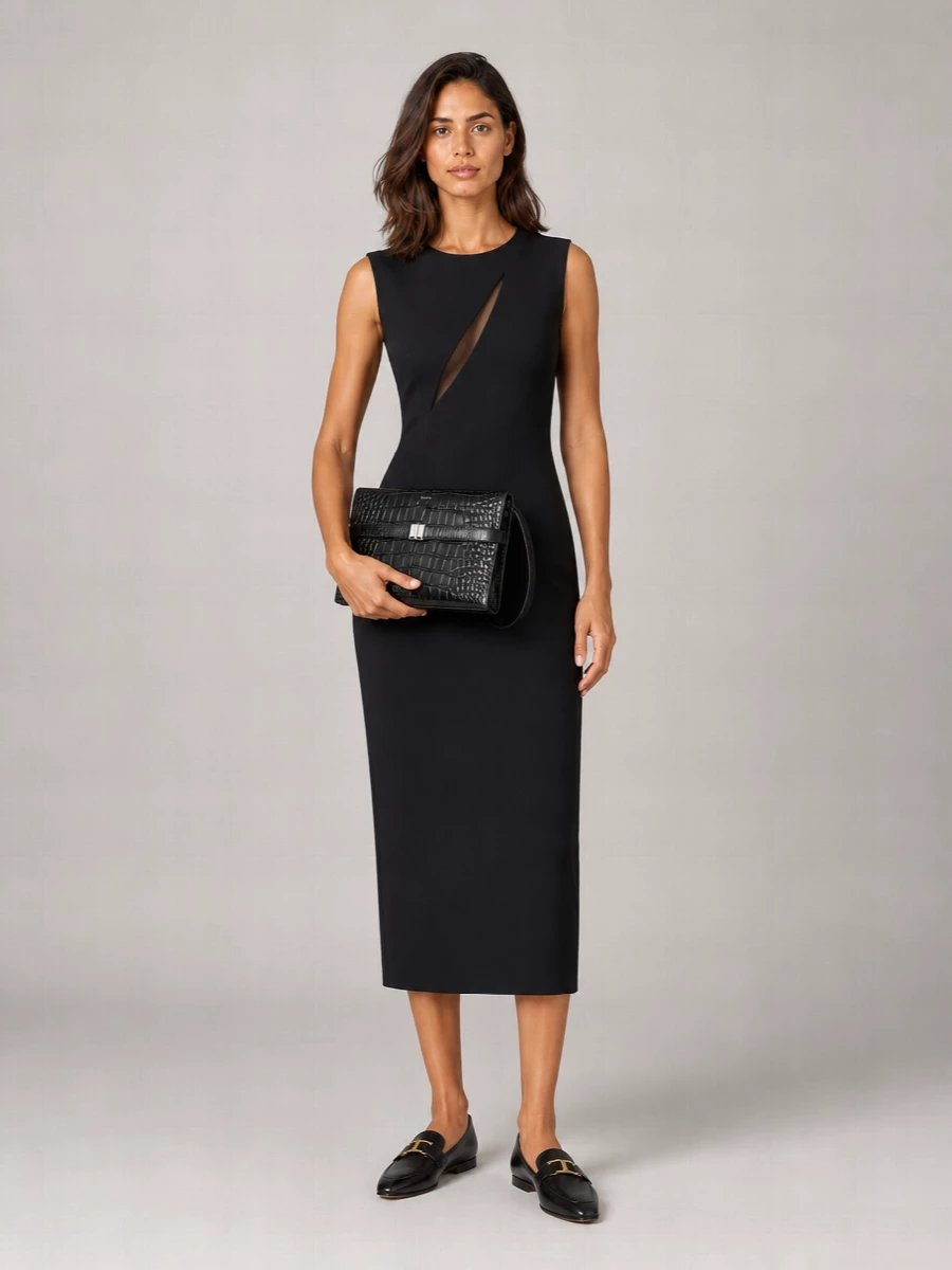 This is a precise, modern evening ensemble built around clean black tailoring and subtle metal hardware that speaks the same language as the Tom Ford cardholder. Opting for the single Versace sheath rather than a full suit keeps the silhouette streamlined and quietly dramatic, letting proportion and cut do the work instead of layering. Flat, pointed loafers and a structured clutch maintain authority and comfort without diluting the polished, minimalist attitude.