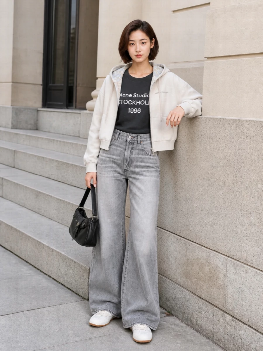 I’m building around the hoodie with denim rather than a dress so the Acne Studios language, plaid lining and soft ivory stay casual and easy. The long grey logo tee and ultra-wide grey jeans create a neat play of proportions, cropped over long, with the neutral runners and compact black shoulder bag keeping everything grounded and city-ready. It feels like a quietly graphic, Scandinavian streetwear uniform you can wear on repeat.