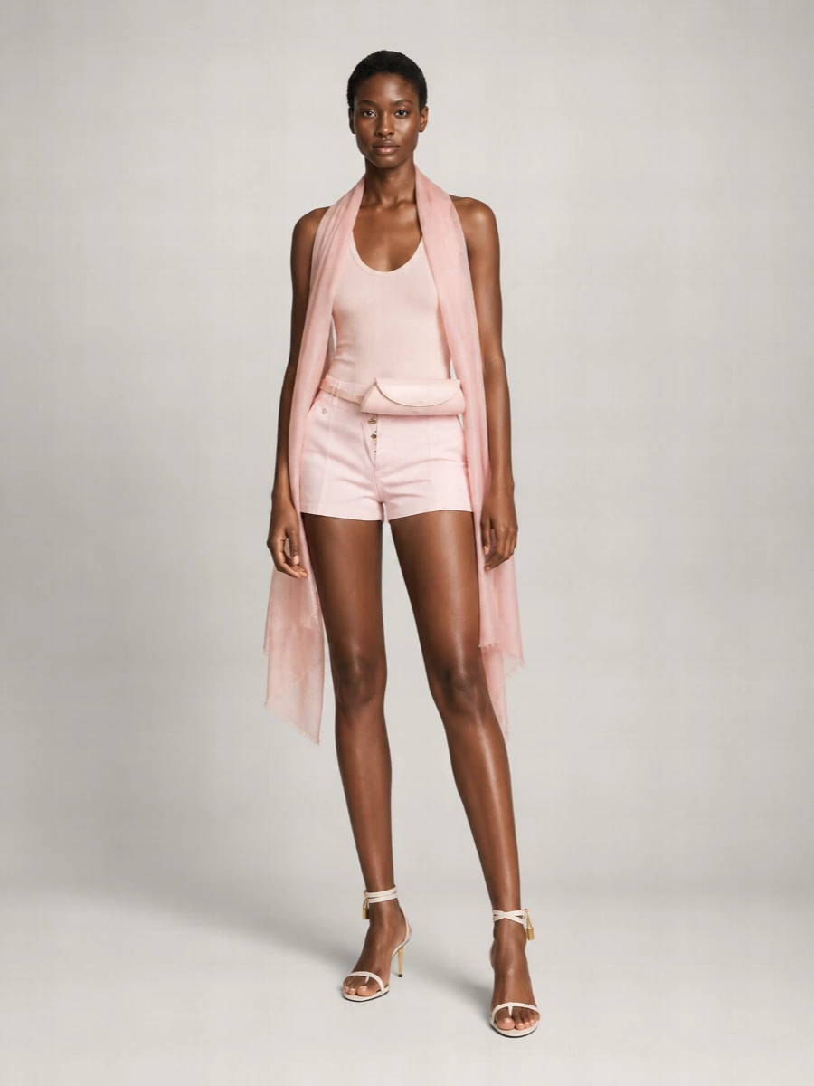 Soft blush tones keep this outfit serene and modern, pairing the tailored shorts with a slim ribbed tank for an easy, elongated line. Ivory stilettos and a blush belt bag add just enough structure and shine while staying quietly in the same pastel register. The result is polished warm-weather dressing that moves effortlessly from brunch to terrace cocktails.