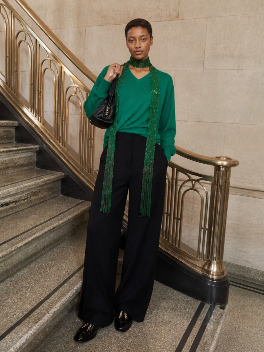 Emerald and deep black form a clean, graphic base, with the draped knit and ultra-wide trouser building a relaxed but precise silhouette. Backless loafers and a soft black pouch keep everything quiet and considered while the slim hit of emerald at the neck adds a controlled sense of movement. The result is an easy city uniform that feels calm yet distinctly designed.