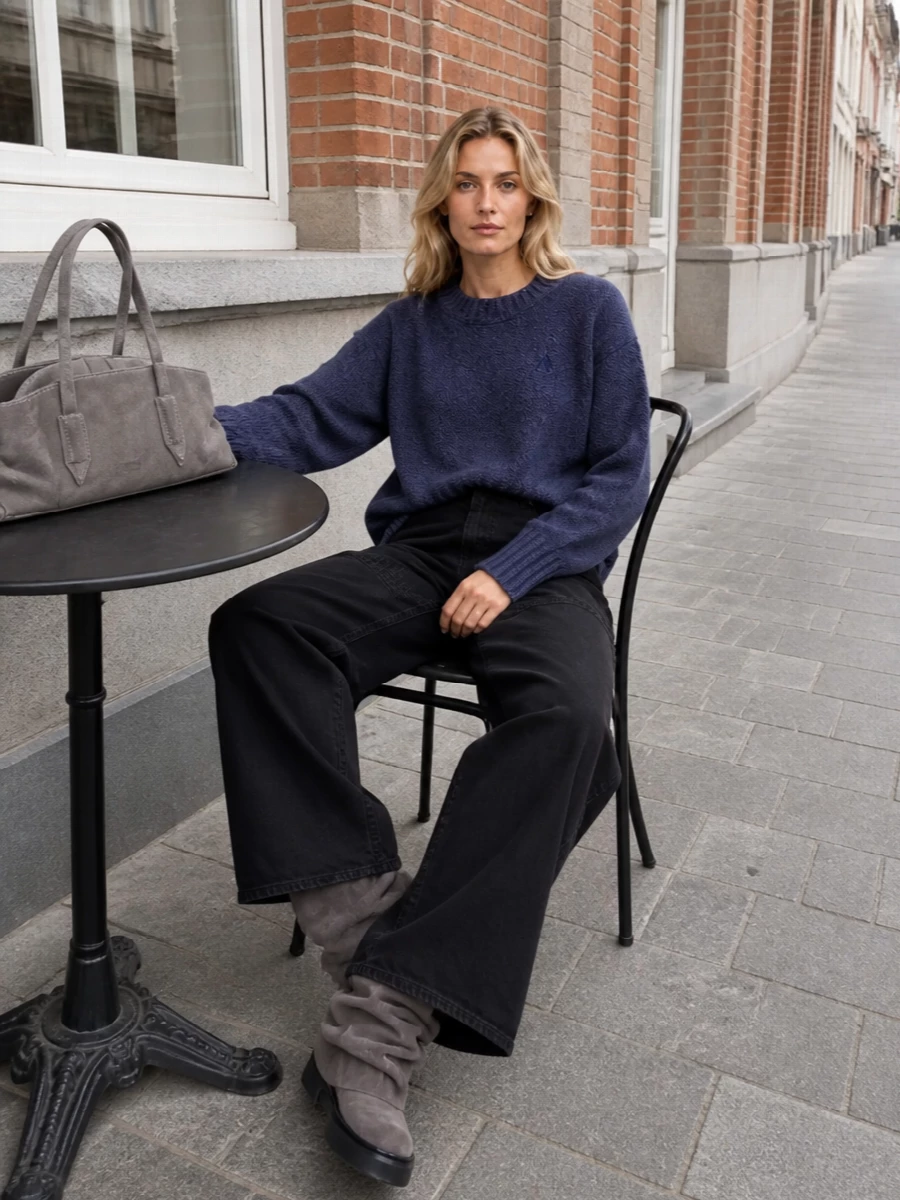 Heathered indigo and washed black anchor a soft, low-contrast palette that feels calm but still city ready. The wide-leg denim and slouchy wedge boots work together to elongate the line while keeping the attitude relaxed. A smoky suede shoulder bag and inky scarf finish it with a hushed, considered polish that still reads off duty.