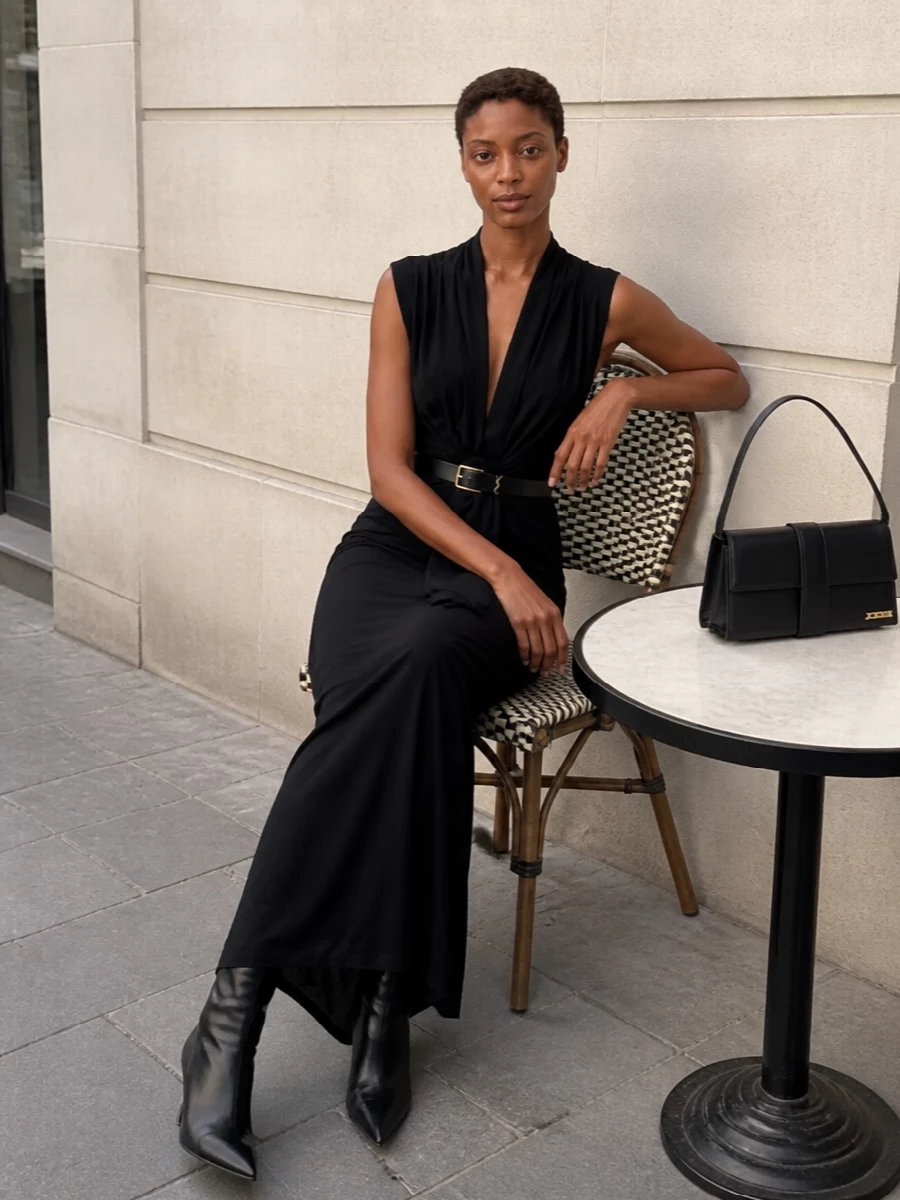 A pure black Gaultier column, this pairing leans into fluid jersey and asymmetric draping for a quietly sensual evening statement. The high waist and long fall stay uninterrupted, with sharp, sculpted accessories in black and gold adding just enough structure and polish. It is made for gallery nights and late dinners where you want precision without noise.