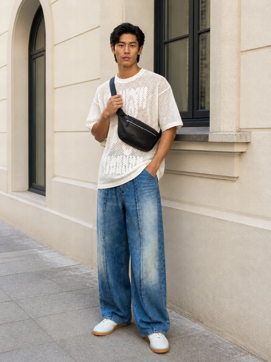 An oversized mesh Margiela tee sits over sculptural wide-leg denim, leaning into a loose, graphic summer proportion. Dip-dyed sneakers and a padded crescent bag keep the palette soft and the details quietly directional. It feels ready for late city days that slide into club nights without changing a thing.