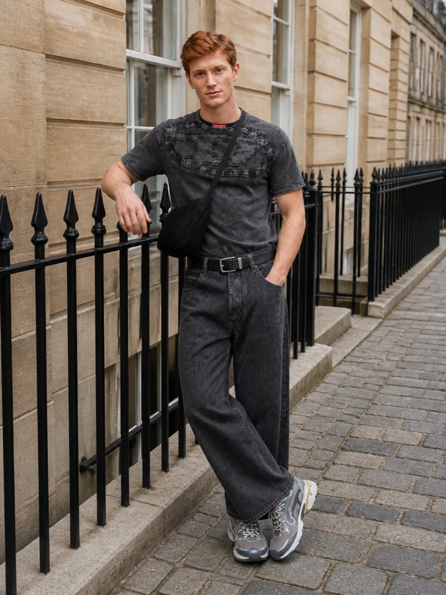 A dark, utility-led palette keeps this outfit sharp, with the structured grey tee and cropped wide-leg denim creating a strong, grounded frame. Technical runners inject subtle Y2K energy and movement, while the sculptural crossbody and clean belt keep everything tight, functional and city-ready. It is a modern street uniform that feels considered without losing that rough Diesel attitude.