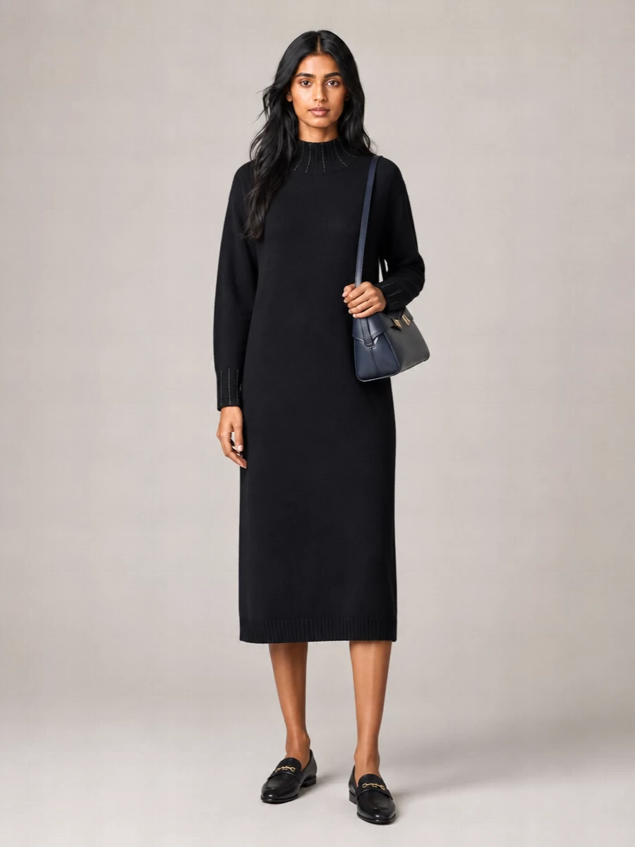 A black knitted midi and sleek loafers frame the navy Ferragamo shoulder bag in a clean, city-ready palette. The straight, cocooned line feels composed but relaxed, ideal for days that slide into dinner. Choosing the dress route keeps the story minimal and uninterrupted, letting structure and texture do the work instead of extra separates.