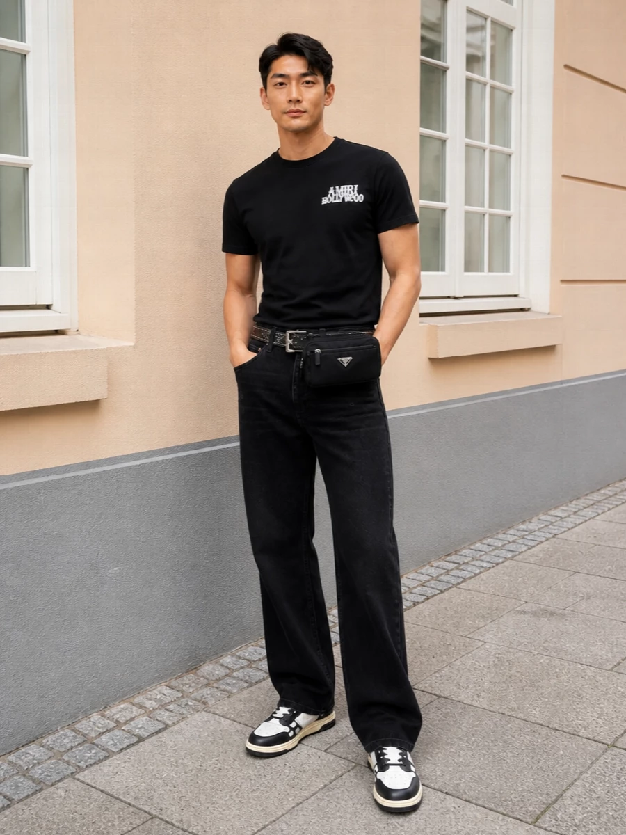 Monochrome Amiri at its sharpest: the Hollywood tee sits against relaxed washed-black denim for a clean, grunge-lean street profile. Graphic black and cream sneakers echo the tee’s contrast, while the Prada belt bag and studded Amiri belt add subtle structure and movement without diluting the black-focused palette. It is an easy, confident uniform for city days that can slide straight into after-dark plans.