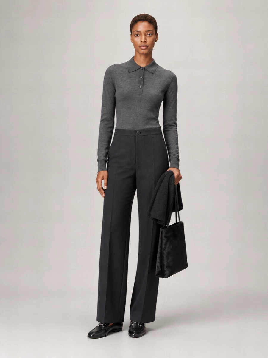 A charcoal-on-charcoal story that feels quietly assured, this pairing leans into clean lines and long proportions for a modern city uniform. The fine-knit polo tucks neatly into high-waisted wide-leg trousers, creating an elongated column that reads polished without feeling stiff. Black leather loafers and a slim structured tote keep the finish sharp and minimal, ideal from office hours to late dinners.