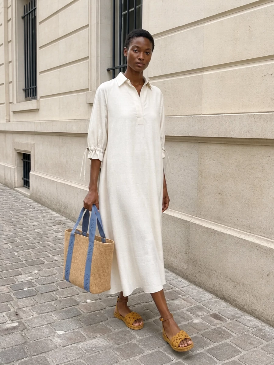 I’ve built the look around the dress path to keep the outfit effortless and columnar, letting the Chloé tote and artisanal sandals do the textural storytelling without the interruption of a separate top and bottom. The Max Mara ivory shirt dress offers a languid, cinchable shape that feels equally at home in the city or by the coast, while the braided Valentino flats pick up the bag’s natural weave and warm tones for a cohesive, polished boho SS ensemble. The result is an easy, elevated uniform where every neutral feels intentionally sun-washed rather than basic.